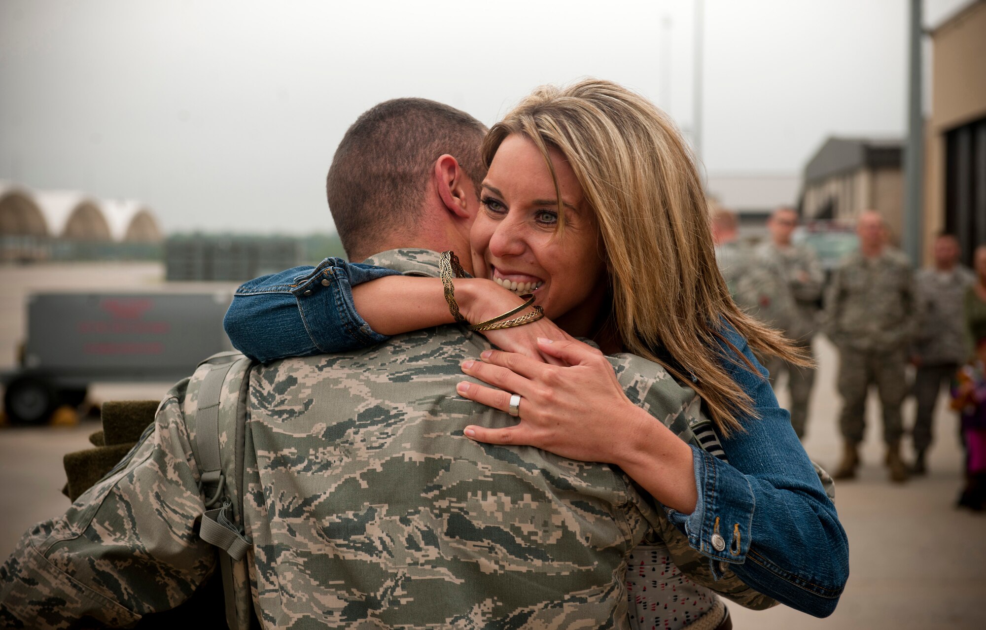 Sandra Sadler gives a hug to her husband Tech. Sgt. Brian Sadler, 23rd Equipment Maintenance Squadron munitions flight conventional munitions crewmember, during a homecoming ceremony at Moody Air Force Base, Ga., March 29. Sergeant Sadler made it home from his six-month deployment just in time for his and his wife's three-year anniversary. (U.S. Air Force photo/Airman 1st Class Joshua Green)(RELEASED)