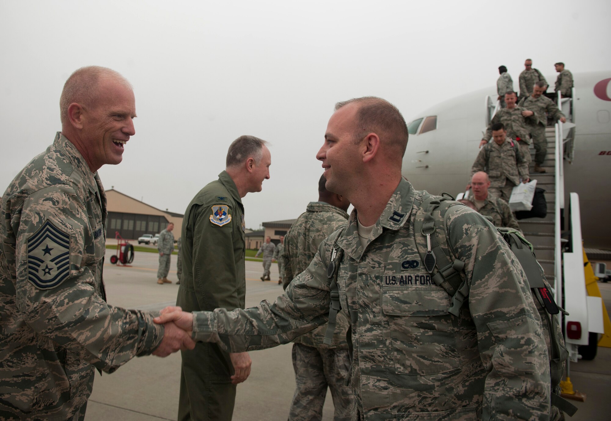 Chief Master Sgt. Frank Batten, 23rd Wing command chief, as well as commanders from around base welcome home returning Airmen after a six month deployment at Moody Air Force Base, Ga., March 29. Family and friends later greeted the Airmen at another location. (U.S. Air Force photo/Airman 1st Class Joshua Green)(RELEASED)