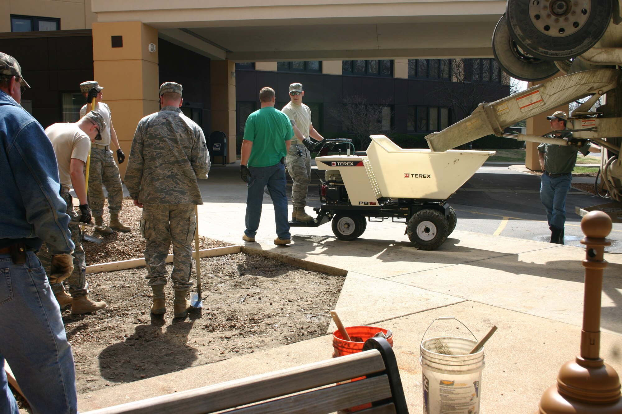 SCOTT AIR FORCE BASE, Ill. -- Members of the 375th Civil Engineer Squadron pour cement to lay the foundation for a new bike rack at the Scott Clinic March 17, 2011. The bike rack is one of two installed on base in preperation for the base's celebration of Earth Week. (Courtesy Photo)