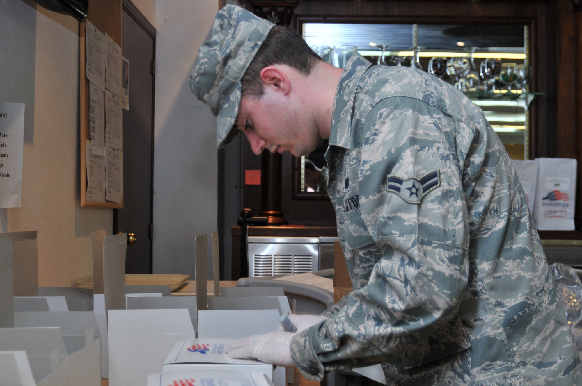 313th AIR EXPEDITIONARY WING -- Airman 1st Class Justin Sullivan, a flight kitchen employee from Spangdahlem Air Base, Germany, prepares flight meals in support of Joint Task Force Odyssey Dawn March 30. Joint Task Force Odyssey Dawn is the U.S. Africa Command task force established to provide operational and tactical command and control of U.S. military forces supporting the international response to the unrest in Libya and enforcement of United Nations Security Council Resolution (UNSCR) 1973. UNSCR 1973 authorizes all necessary measures to protect civilians in Libya under threat of attack by Gadhafi regime forces. JTF Odyssey Dawn is commanded by U.S. Navy Admiral Samuel J. Locklear, III. (U.S. Air Force photo/Senior Airman David Dobrydney/Unreleased)