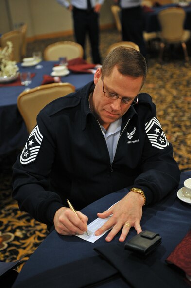 MINOT AIR FORCE BASE, N.D. -- Chief Master Sgt. Kent Smith, 5th Bomb Wing command chief, fills out his Air Force Assistance Fund form at the campaign kickoff breakfast here March 28. The AFAF was established to raise funds for the charitable organizations that provide support for active duty, retirees, reservists, guardsmen and their dependents, including surviving spouses in need. This year’s campaign will run for six weeks from March 28 through May 6. (U.S. Air Force photo/Staff Sgt. Keith Ballard)