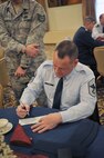 MINOT AIR FORCE BASE, N.D. -- Chief Master Sgt. Bryn LePine, 5th Mission Support Group command chief, fills out his Air Force Assistance Fund form at the campaign kickoff breakfast, here March 28. The AFAF was established to raise funds for the charitable organizations that provide support for active duty, retirees, reservists, guardsmen and their dependents, including surviving spouses in need. This year’s campaign will run for six weeks from March 28 through May 6. (U.S. Air Force photo/Staff Sgt. Keith Ballard)