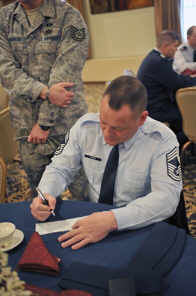 MINOT AIR FORCE BASE, N.D. -- Chief Master Sgt. Bryn LePine, 5th Mission Support Group command chief, fills out his Air Force Assistance Fund form at the campaign kickoff breakfast, here March 28. The AFAF was established to raise funds for the charitable organizations that provide support for active duty, retirees, reservists, guardsmen and their dependents, including surviving spouses in need. This year’s campaign will run for six weeks from March 28 through May 6. (U.S. Air Force photo/Staff Sgt. Keith Ballard)
