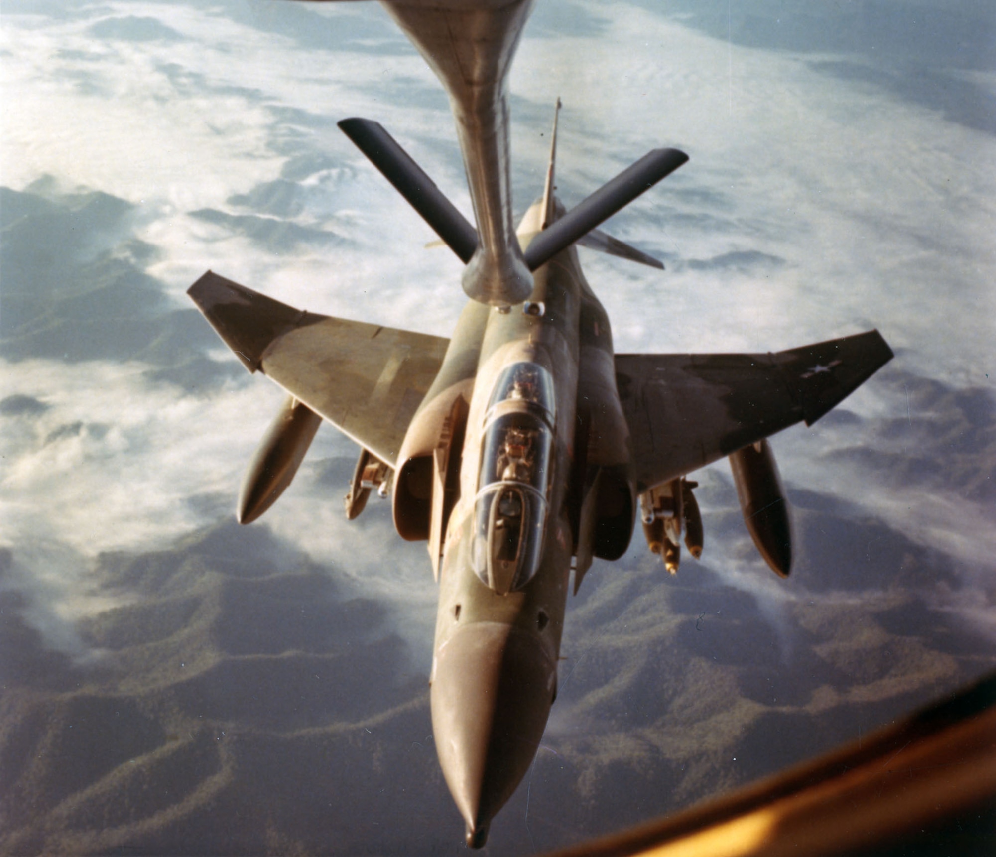 Refueling an F-4 Phantom over rugged Southeast Asian terrain, as seen from the KC-135 boom operator’s point of view, 1967. (U.S. Air Force photo)