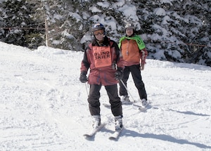 Elden Miller, a former Army sergeant blinded during a truck explosion at Fort Carson, Colo., finds the "miracle on the mountain," while blazing independently down the wide-open spaces of Colorado's Snowmass Mountain March 29, 2011, at the National Disabled Veterans Winter Sports Clinic. Accompanying him is volunteer ski instructor Jerry Miserandino. (Defense Department photo/Donna Miles)