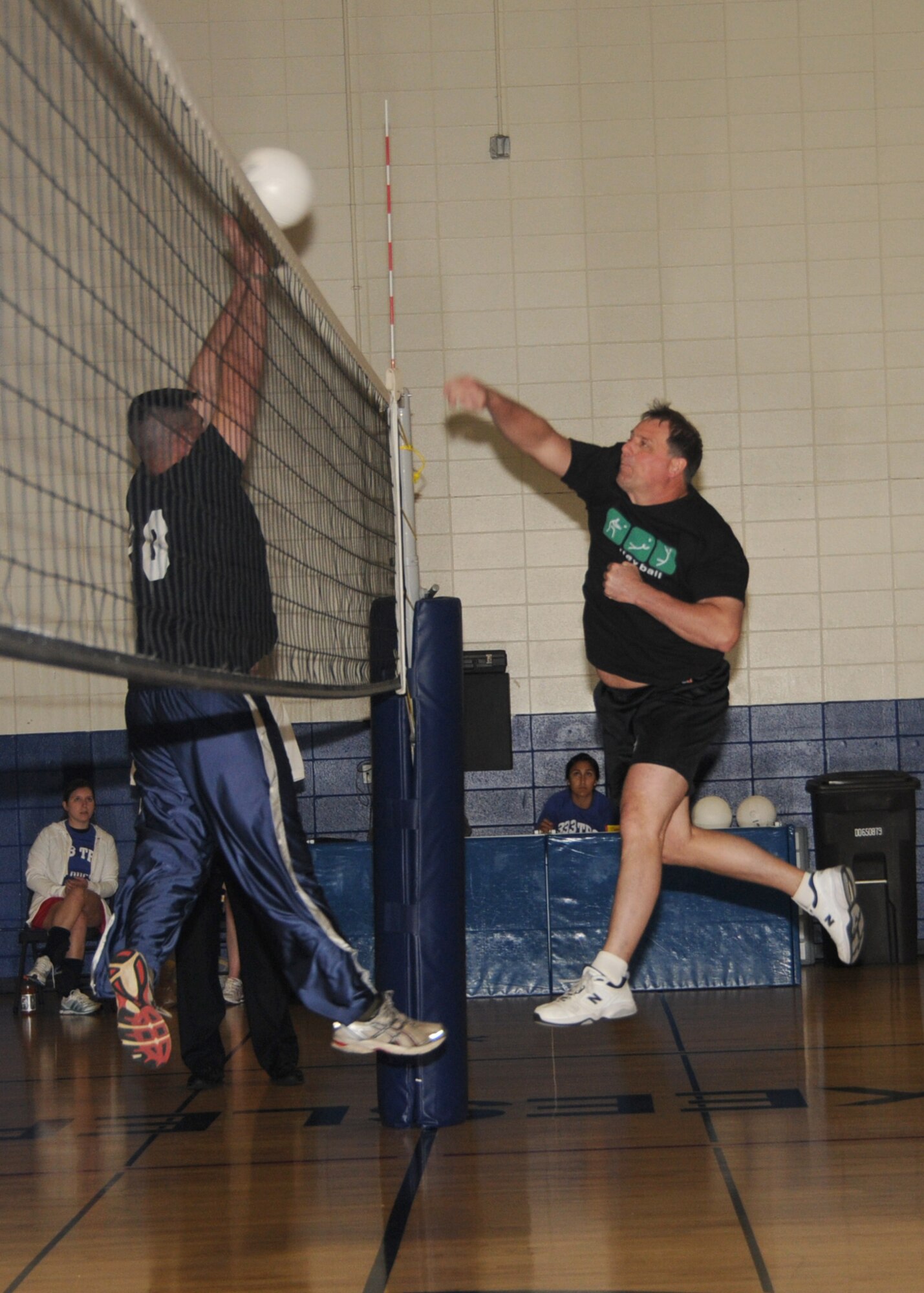 Robert Rakes, left, 81st Logistics Readiness Squadron, goes up for the block after Jeffrey Willoughby spikes the ball for the 338th Training Squadron during an Eastern Conference volleyball game March 21. The 338th TRS won, 2-0, moving into second place in the conference with a 4-2 record behind the undefeated 333rd TRS A-team, 7-0. The 81st LRS dropped to 1-6. The 81st Medical Operations Squadron leads the Western Conference with a 6-1 record.  (U.S. Air Force photo by Kemberly Groue)