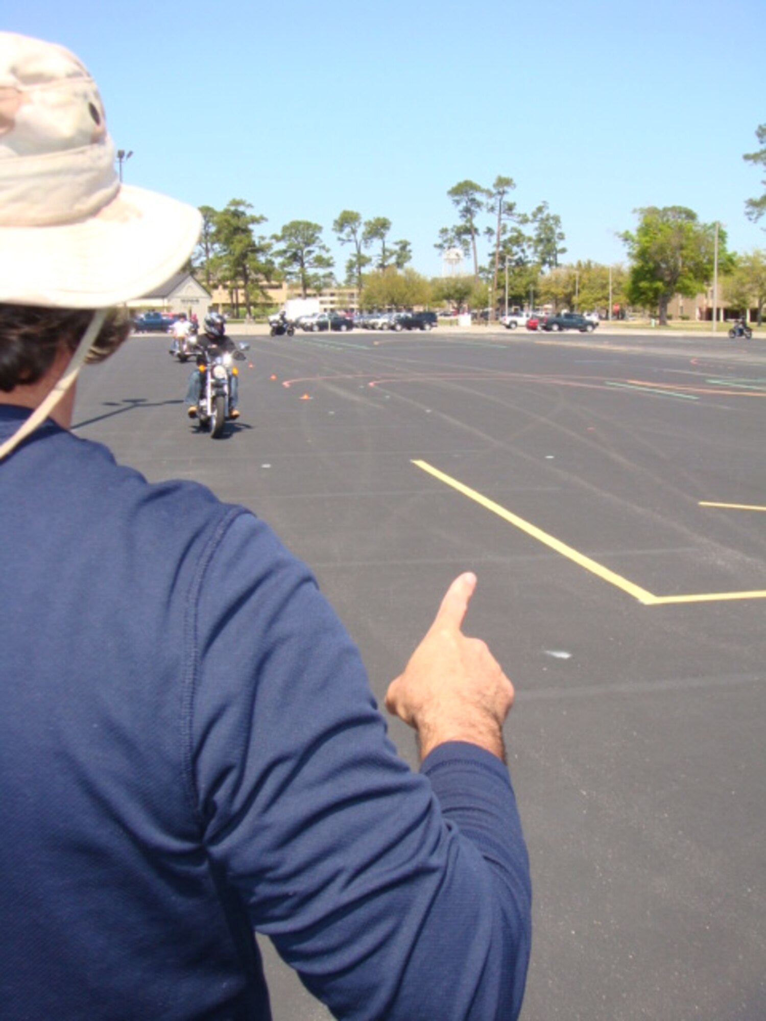 Motorcycle safety instructor Don Eberlin, 338th Training Squadron, evaluates students during an “adjusting speed and turning” exercise at a basic rider course, March 24.  (U.S. Air Force photo by Tech. Sgt. Greg Washburn)