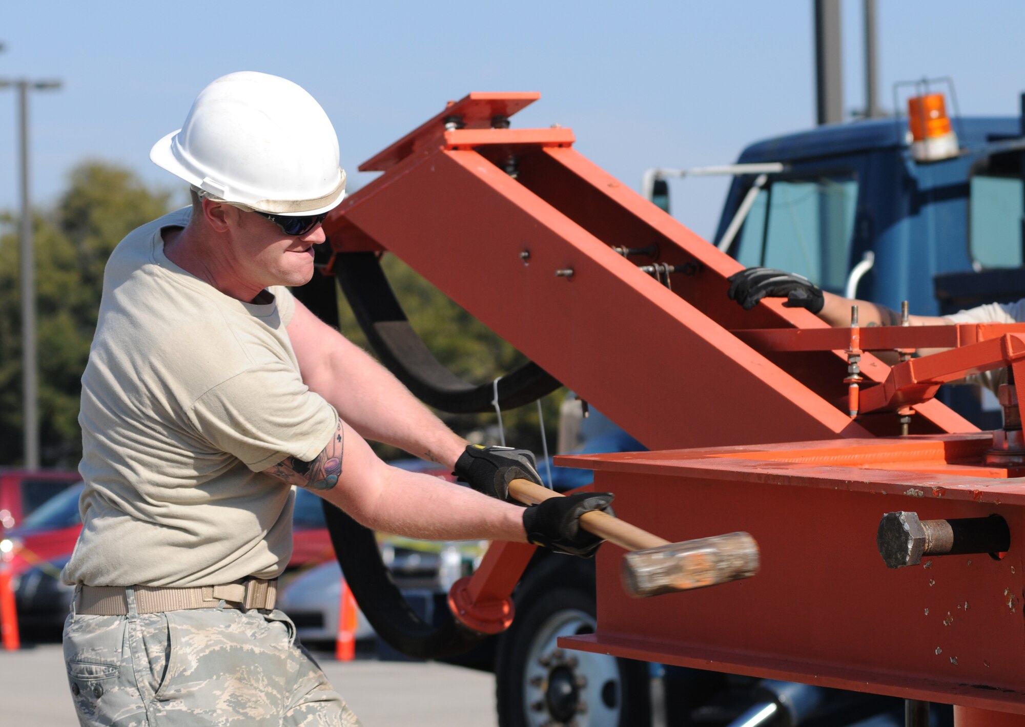 Staff Sgt. Aaron Bryars puts the finishing touches on the radar dismantling as he pounds out a retaining pin in the antenna pedestal, Feb. 15.  (U.S. Air Force photo by Kemberly Groue)