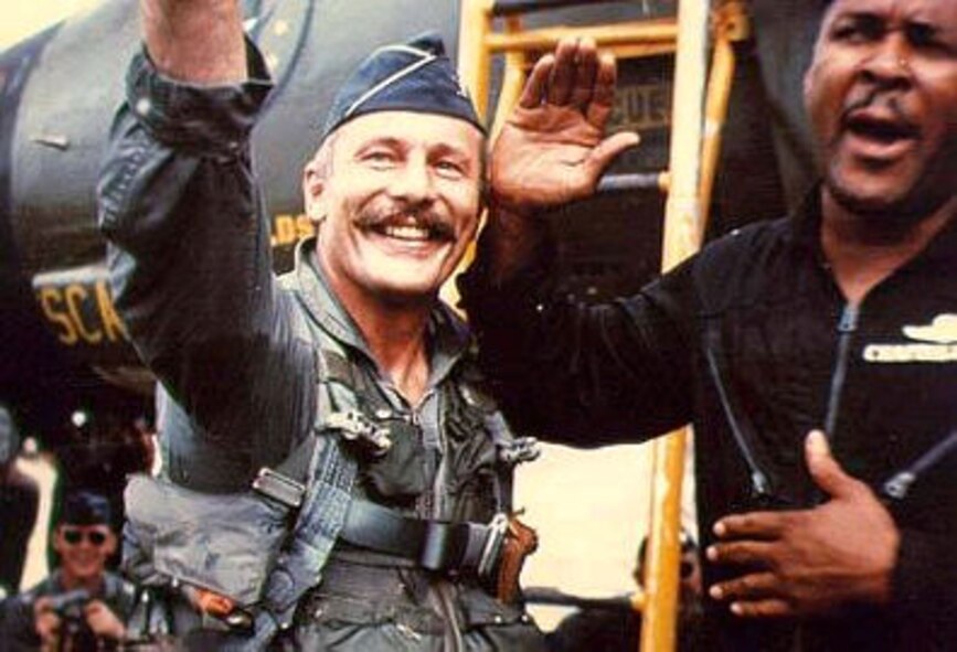 Brig. Gen. Robin Olds, left, 8th Tactical Fighter Wing commander, participates in the first ever Mustache March during the Vietnam War in 1965. General Olds is noted as the pioneer and creator of the month-long tradition which is still practiced and celebrated today. (U.S. Air Force courtesy photo)