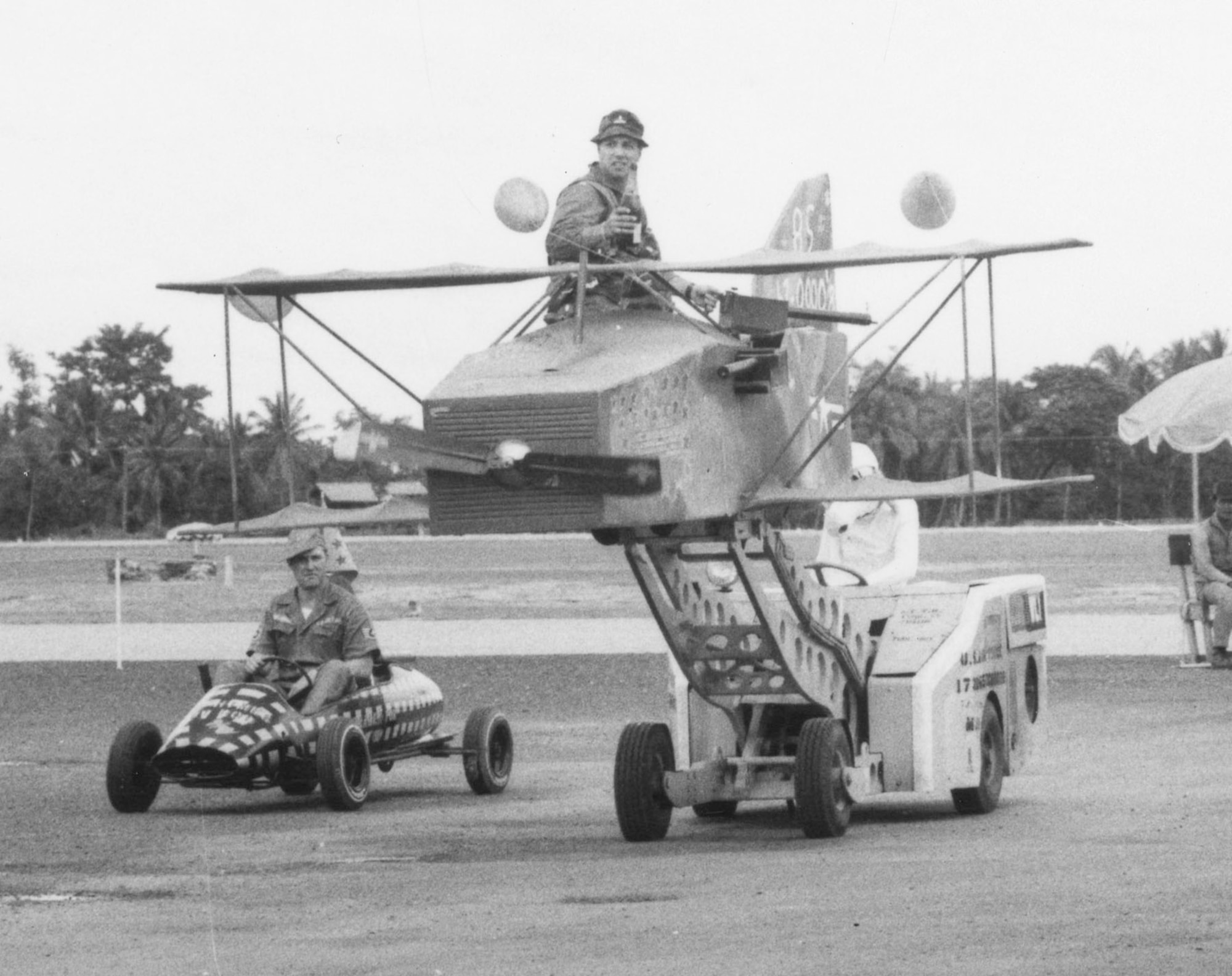 Pictured here are a few of the many funny, creative floats made for the “practice reunion” parades. The “biplane” is sitting on top a bomb loader. (U.S. Air Force photo)