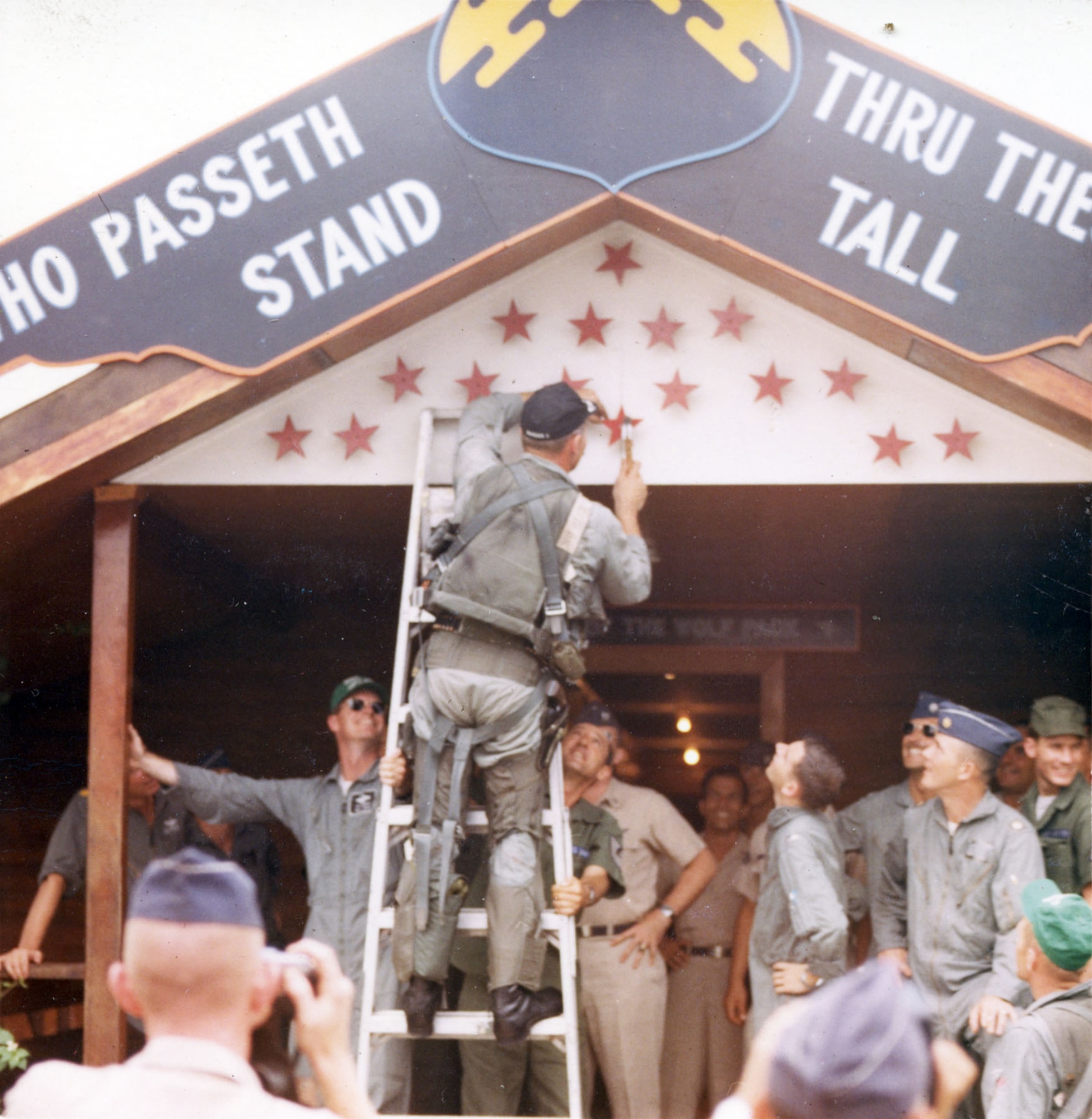 Col. Robin Olds, 8th Tactical Fighter Wing commander, nailing up one of his MiG kills after a successful mission. The words above read “Ye who passeth thru these portals stand tall.” (U.S. Air Force photo)