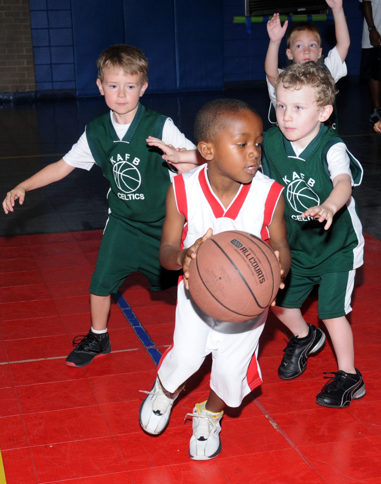 Messiah Washington is pursued by Jason Hutchinson, left, and Tristan Fisher during one of Saturday’s basketball games at the youth center. Messiah, 5, is the son of Tech. Sgts. Jason and Tomeika Washington, 333rd Training Squadron. Jason, 6, is the son of Capt. Krista Hutchinson, 81st SurgicalOperations Squadron, and Petty Officer 3rd Class Dean Hutchinson,VR 54 Naval Air Station Joint Reserve Base, New Orleans, La. Five-year-old Tristan’s parents are Master Sgt. Anthony and Holly Fisher, 81st Training Group.  (U.S. Air Force photo by Kemberly Groue)