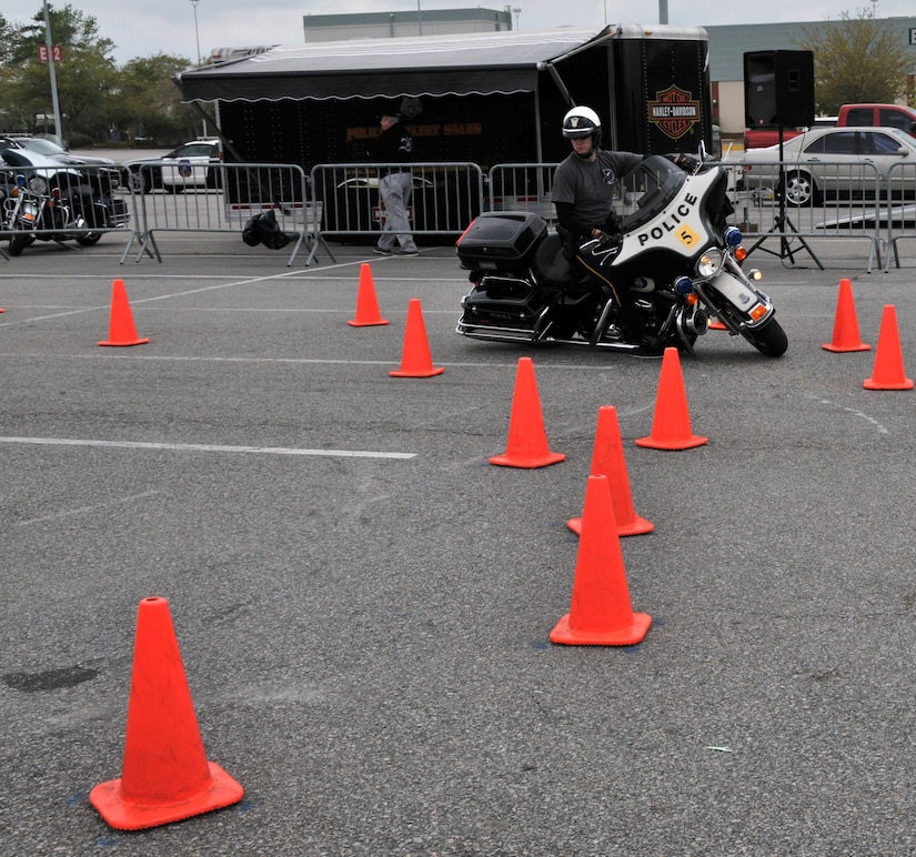 A police officer shows off his maneuvering skills March 25 during the 6th Annual Palmetto Police Motorcycle Rodeo. The rodeo was one of the stops of the 2011 Joint Base Charleston Motorcycle Safety Event where attendees learned about motorcycle laws in South Carolina and tips were given on safe riding. (U.S. Air Force photo/Airman 1st Class Jared Trimarchi)