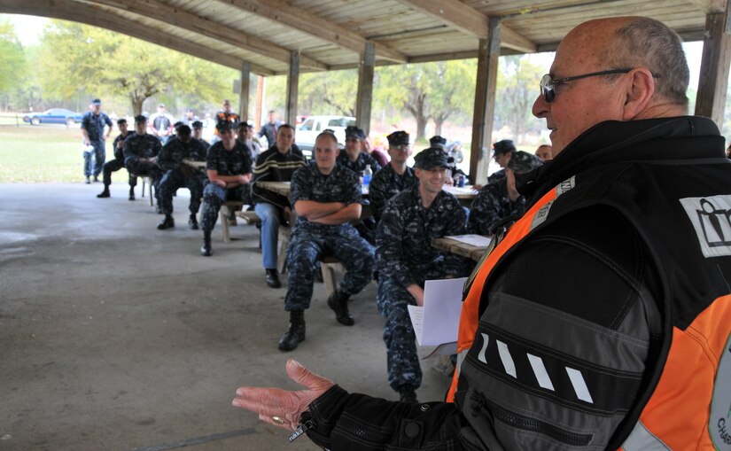 Louis Pechon, a Joint Base Charleston motorcycle instructor from Cape Fox, talks to Sailors about the importance of safe riding during the 2011 Joint Base Charleston Motorcycle Safety Event, March 25 at JB CHS - Weapons Station. Mr. Pechon discussed topics such as riding too fast, braking tips and the importance of correct cornering. He also answered questions Sailors asked about safety and riding on a closed track. To sign up for a motorcycle class, visit www.navymotorcyclerider.com. (U.S. Air Force photo/Airman 1st Class Jared Trimarchi)

