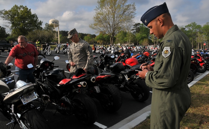 Stuart Wyatt (left), from the 628th Air Base Wing safety office, Command Chief Master Sgt. Jose LugoSantiago, 628th Air Base Wing Command Chief, and Col. Brian Robinson, 437th Airlift Wing vice commander, decide on the best sport bike at the 2011 Joint Base Charleston Motorcycle Safety Event, March 25 at the JB CHS - Air Base theater. Three hundred Airmen, Sailors, civilians and dependents attended the event which included a ride to the Navy?s outdoor recreation facility, Short Stay, and a trip to the North Charleston Coliseum to witness the 6th Annual Palmetto Police Motorcycle Rodeo.  (U.S. Air Force photo/Airman 1st Class Jared Trimarchi)