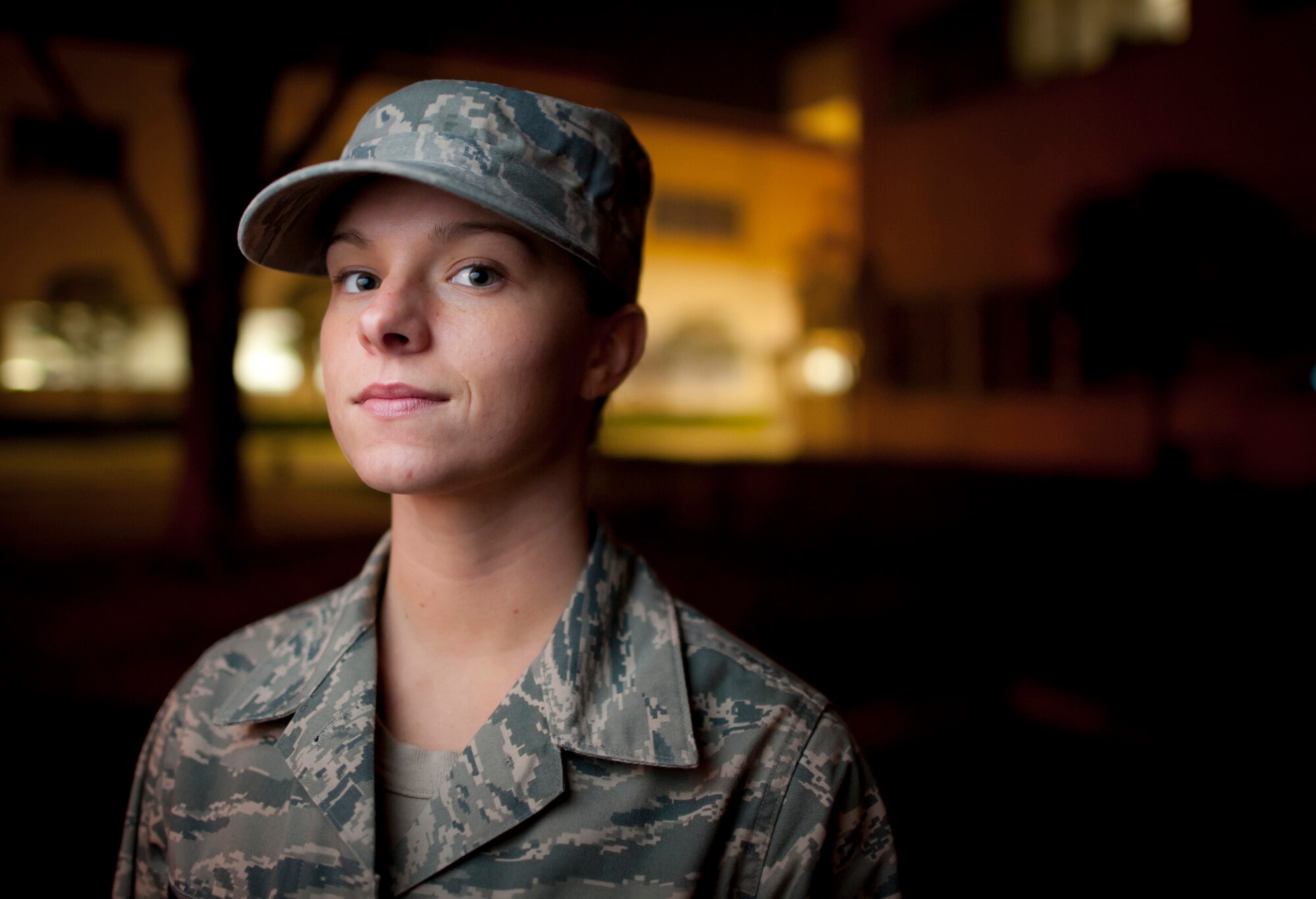 YOKOTA AIR BASE, Japan -- Senior Airman Megan Dean, 374th Airlift Wing command post, stands in front of the wing headquarters building on night shift at Yokota Air Base, Japan, March 29, 2011. In support of Operation Tomodachi, Airman Dean monitors and tracks incoming and outgoing flights, directing base agencies needing to resupply and support those flights. She said, "Japan really needs the support of everyone, not just our military right now. I feel like I'm in the right place doing what I should be to help." Airman Dean is a native of Charlestown, Ind. (U.S. Air Force photo/Staff Sgt. Samuel Morse)