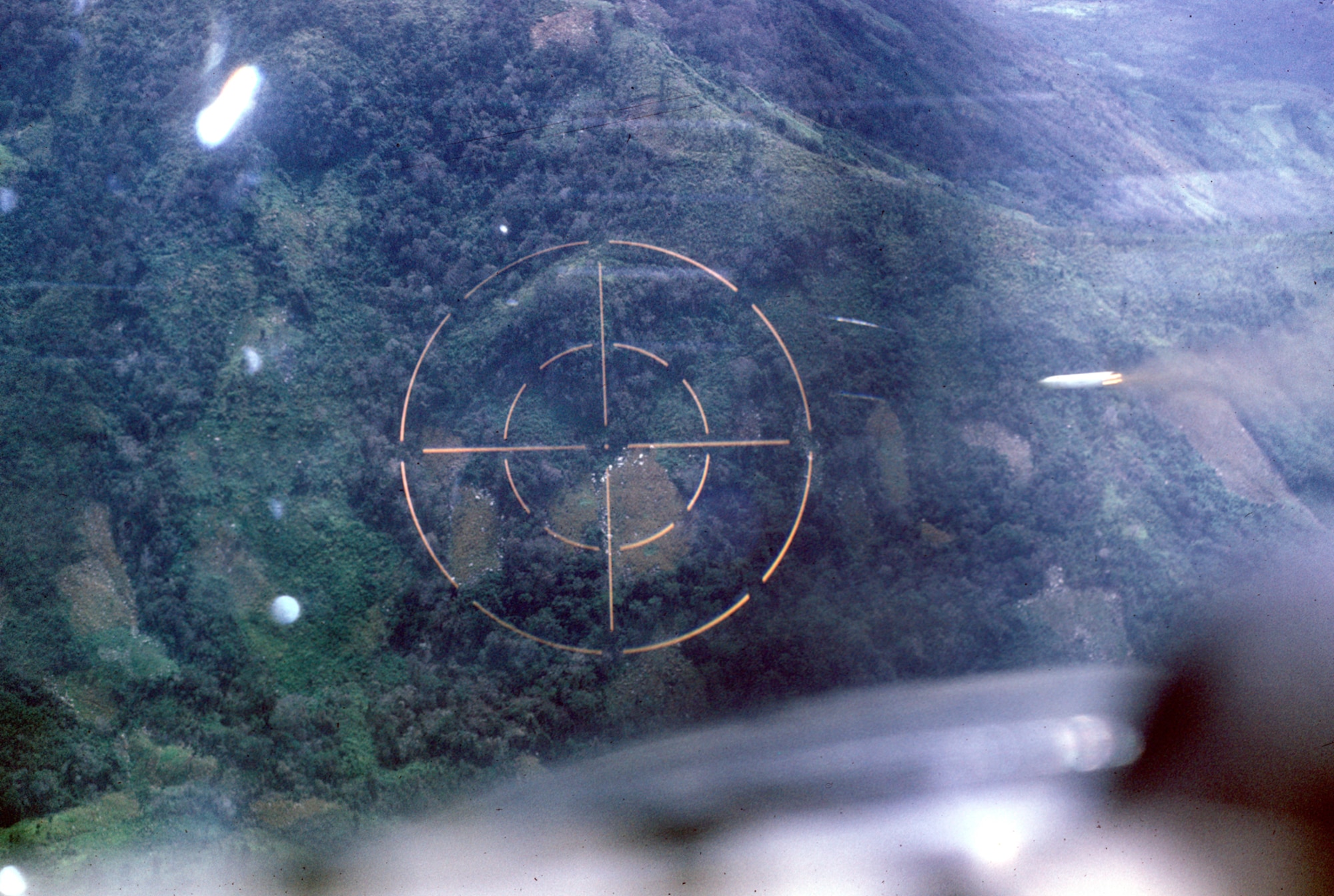 Pilot's view of marking a target with white phosphorus rockets. U.S. Air Force FACs found and marked targets on the Ho Chi Minh Trail. (U.S. Air Force photo).