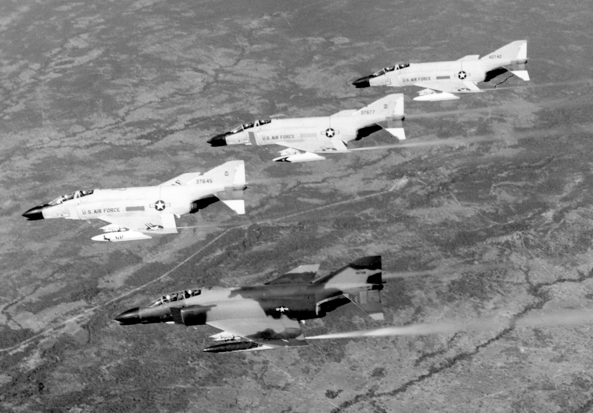 Early F-4s in Southeast Asia were painted gray, but by 1966, they were camouflaged like the Phantom at the bottom of the photograph. (U.S. Air Force photo)