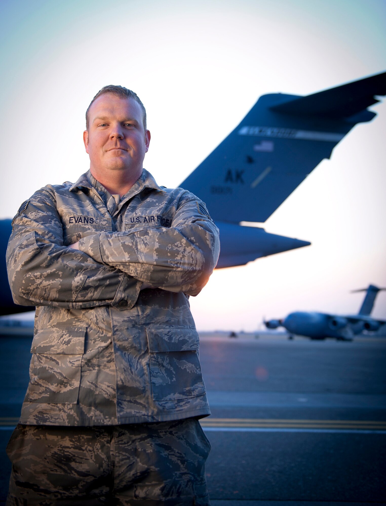 YOKOTA AIR BASE, Japan -- Staff Sgt. Christopher Evans, 730th Air Mobility Squadron crew chief, stands in front of a C-17 Globemaster III here March 30. Sergeant Evans hails from Bradenton, Fla. (U.S. Air Force photo/Staff Sgt. Chad C. Strohmeyer)
