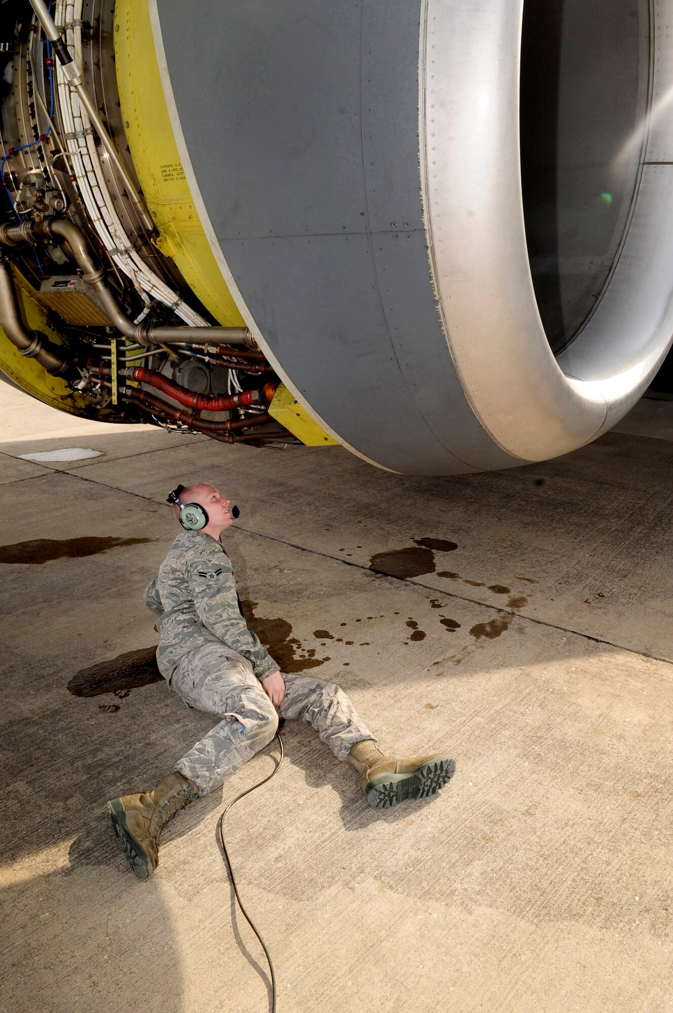 313TH AIR EXPEDITIONARY WING -- A 92nd Aircraft Maintenance Squadron jet mechanic from Fairchild Air Force Base, Wash., inspects a KC-135 engine here during an engine run in support of Joint Task Force Odyssey Dawn March 26. Joint Task Force Odyssey Dawn is the U.S. Africa Command task force established to provide operational and tactical command and control of U.S. military forces supporting the international response to the unrest in Libya and enforcement of United Nations Security Council Resolution (UNSCR) 1973. UNSCR 1973 authorizes all necessary measures to protect civilians in Libya under threat of attack by Gadhafi regime forces. JTF Odyssey Dawn is commanded by U.S. Navy Admiral Samuel J. Locklear, III. (U.S. Air Force photo/Senior Airman Ethan Morgan)