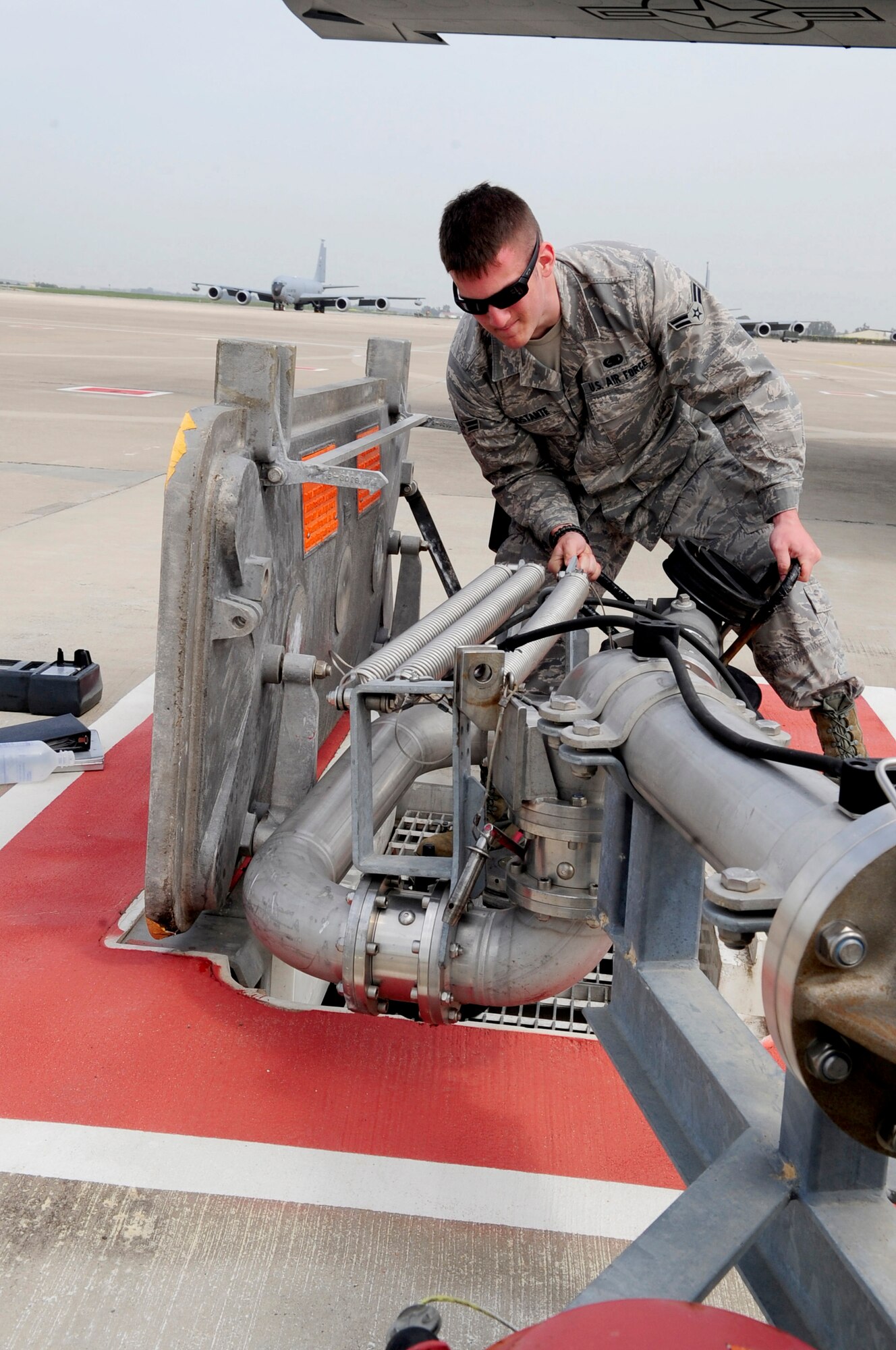 313TH AIR EXPEDITIONARY WING -- An Airman from the 100th Logistics Readiness Squadron attaches a pantograph to an underground fuel source to refuel a KC-135 Stratotanker during the current ongoing mission in support of Joint Task Force Odyssey Dawn March 25. Joint Task Force Odyssey Dawn is the U.S. Africa Command task force established to provide operational and tactical command and control of U.S. military forces supporting the international response to the unrest in Libya and enforcement of United Nations Security Council Resolution (UNSCR) 1973. UNSCR 1973 authorizes all necessary measures to protect civilians in Libya under threat of attack by Gadhafi regime forces. JTF Odyssey Dawn is commanded by U.S. Navy Admiral Samuel J. Locklear, III. (U.S. Air Force photo/Senior Airman Ethan Morgan)