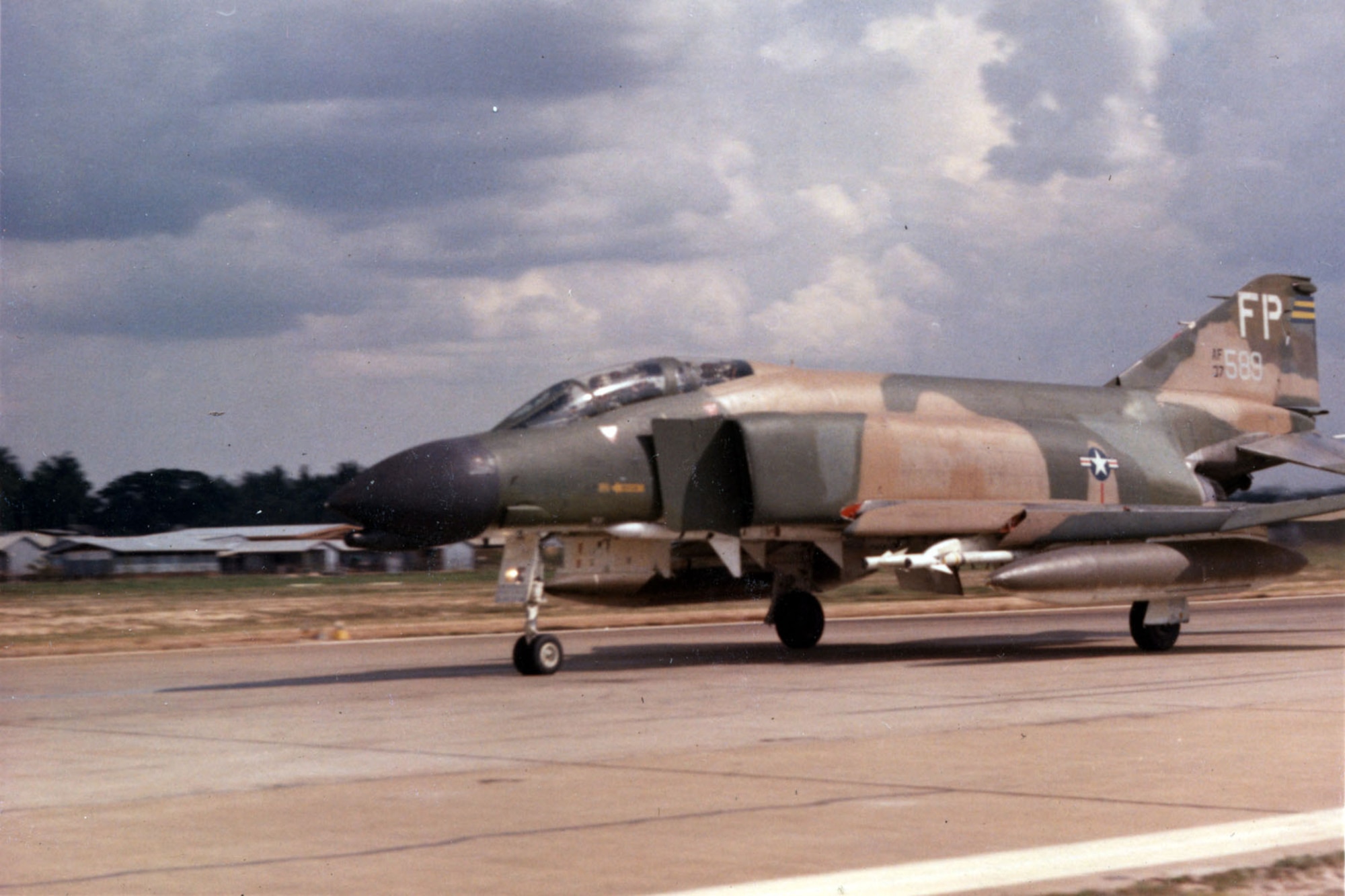 F-4C of the 497th Tactical Fighter Squadron, 8th Tactical Fighter Wing, rolls out on takeoff. It is configured for the MiGCAP escort role with Sparrow air-to-air missiles under the fuselage, and Sidewinder air-to-air missiles and extra fuel tanks under the wings. (U.S. Air Force photo)