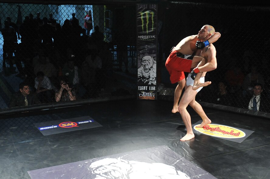 SEYMOUR JOHNSON AIR FORCE BASE, N.C. -- Mike Powell prepares to body slam Salah Hemidach on the mat during the main event of the mixed martial arts cage fight here, March 25, 2011. Powell remains undefeated with a record of six wins and zero losses. Hemidach is a native of Charlotte and Powell hails from Kannapolis. (U.S. Air Force photo/Senior Airman Whitney Lambert) (RELEASED)