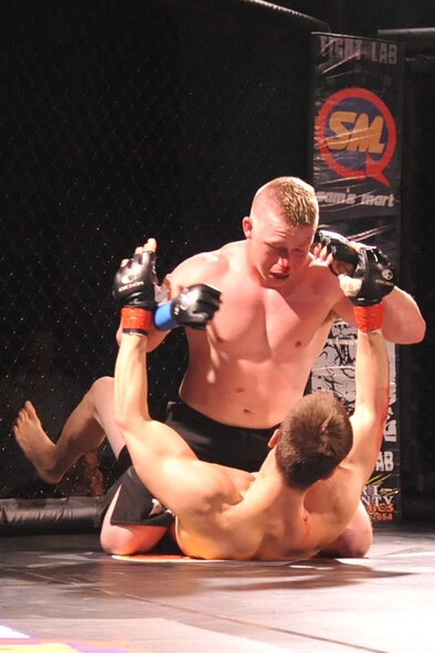 SEYMOUR JOHNSON AIR FORCE BASE, N.C. -- Kevin Kenna defeats Stephen Hudson during a mixed martial arts cage fight here, March 25, 2011. Kenna won match in the second round with 2 minutes and 53 seconds left by submission after a body slam. Kenna, a U.S. Army soldier, hails from Goldsboro. (U.S. Air Force photo/Senior Airman Whitney Lambert) (RELEASED)