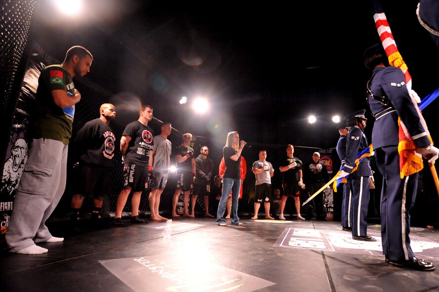 SEYMOUR JOHNSON AIR FORCE BASE, N.C. -- Tech. Sgt. Tina McCloskey sings the National Anthem to begin a series of mixed martial arts cage fights here, March 25, 2011. Fight Lab promotions hosted the MMA fights for local servicemembers. Sergeant McCloskey is assigned to the 4th Force Support Squadron. (U.S. Air Force photo/Senior Airman Whitney Lambert) (RELEASED)