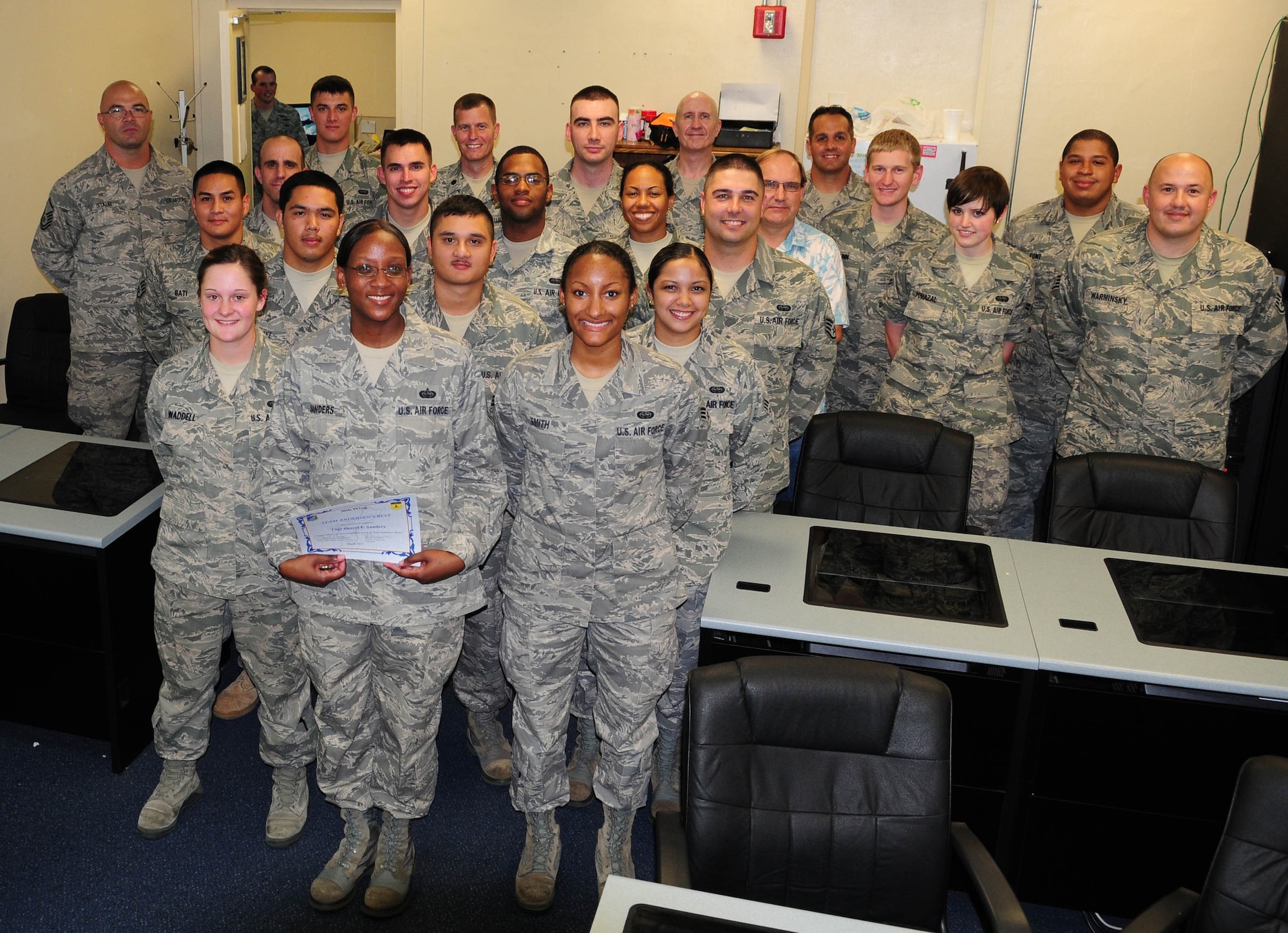 Tech. Sgt Sharel Sanders, 36th Communication Squadron Client Systems Team noncommissioned officer in charge, poses with the Client Service Team, after being awarded Andersen’s Best here, Mar. 25.  Sergeant Sanders was recognized for her superior performance leading her team in completing 289 work orders in nine duty days.  (U.S. Air Force photo/Staff Sgt. Jamie Powell)