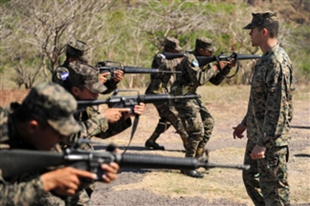 U.S. Marine Corps Staff Sgt. Daniel Monteiro (right), assigned to Marine Corps Training and Advisory Group, teaches proper tactical movement techniques to a group of soldiers assigned to 11th Honduran army battalion during a week-long subject matter expert exchange in support of Southern Partnership Station 2011 in San Lorenzo, Honduras, on March 15, 2011.  Southern Partnership Station is an annual deployment of U.S. ships to the U.S. Southern Command's area of responsibility in the Caribbean and Latin America.  The exercise involves information sharing with navies, coast guards and civilian services throughout the region.  