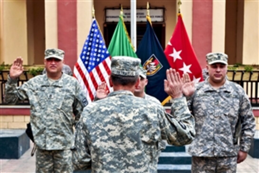 U.S. Army Gen. David H. Petraeus, commander of U.S. and NATO forces in Afghanistan, administers the oath of re-enlistment to troops in Kabul, Afghanistan, March 29, 2011.
