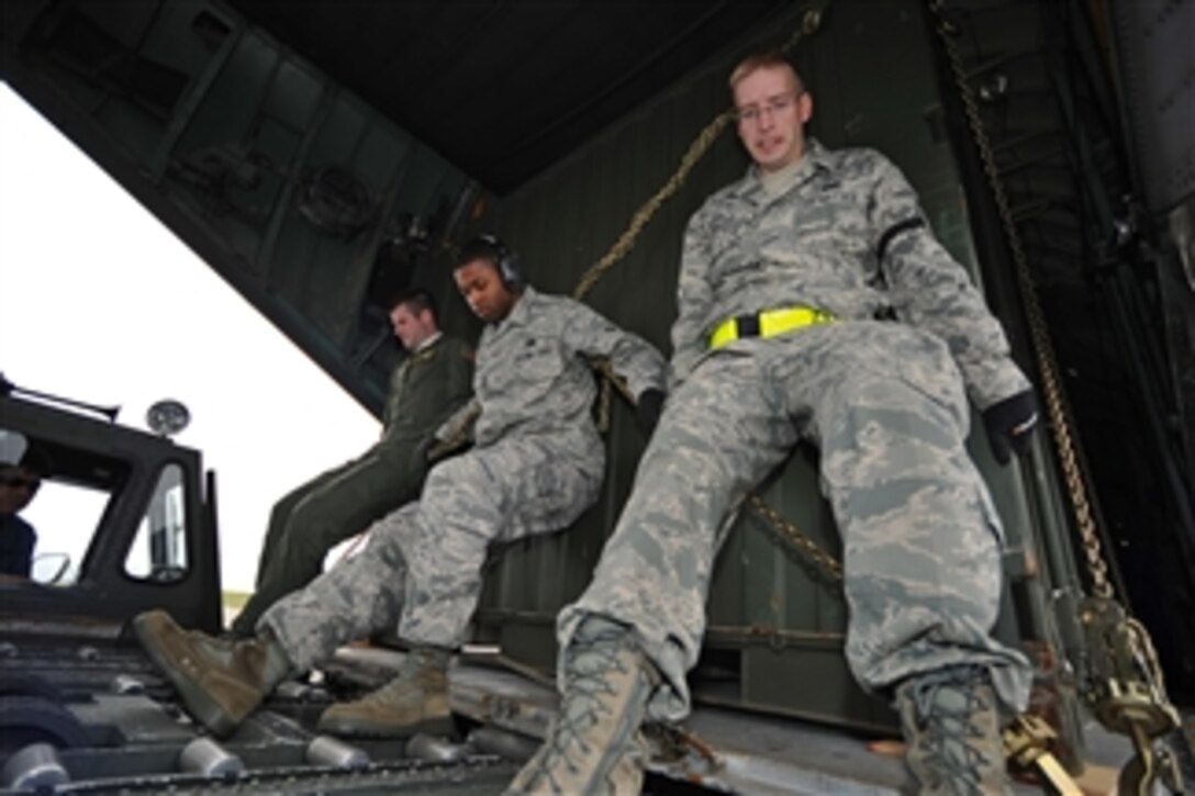 U.S. Air Force airmen load communication equipment into a C-130 Hercules aircraft at Kadena Air Base, Japan, on March 27, 2011.  The aircraft transported equipment to Sendai, Japan, to support U.S. and Japanese relief efforts during Operation Tomodachi.  