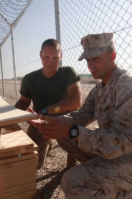 Dalton, Ga., native Cpl. Matthew T. Williams (left) explains some of the things to look for when selecting material for a project. The heavy equipment operator with Company C, 2nd Combat Engineer Battalion, has been working to mentor Marines in the unit while on his second combat tour in Afghanistan. The company is supporting Regimental Combat Team 8 and is stationed at Forward Operating Base Delaram II, Afghanistan. ::r::::n::::r::::n::::r::::n::