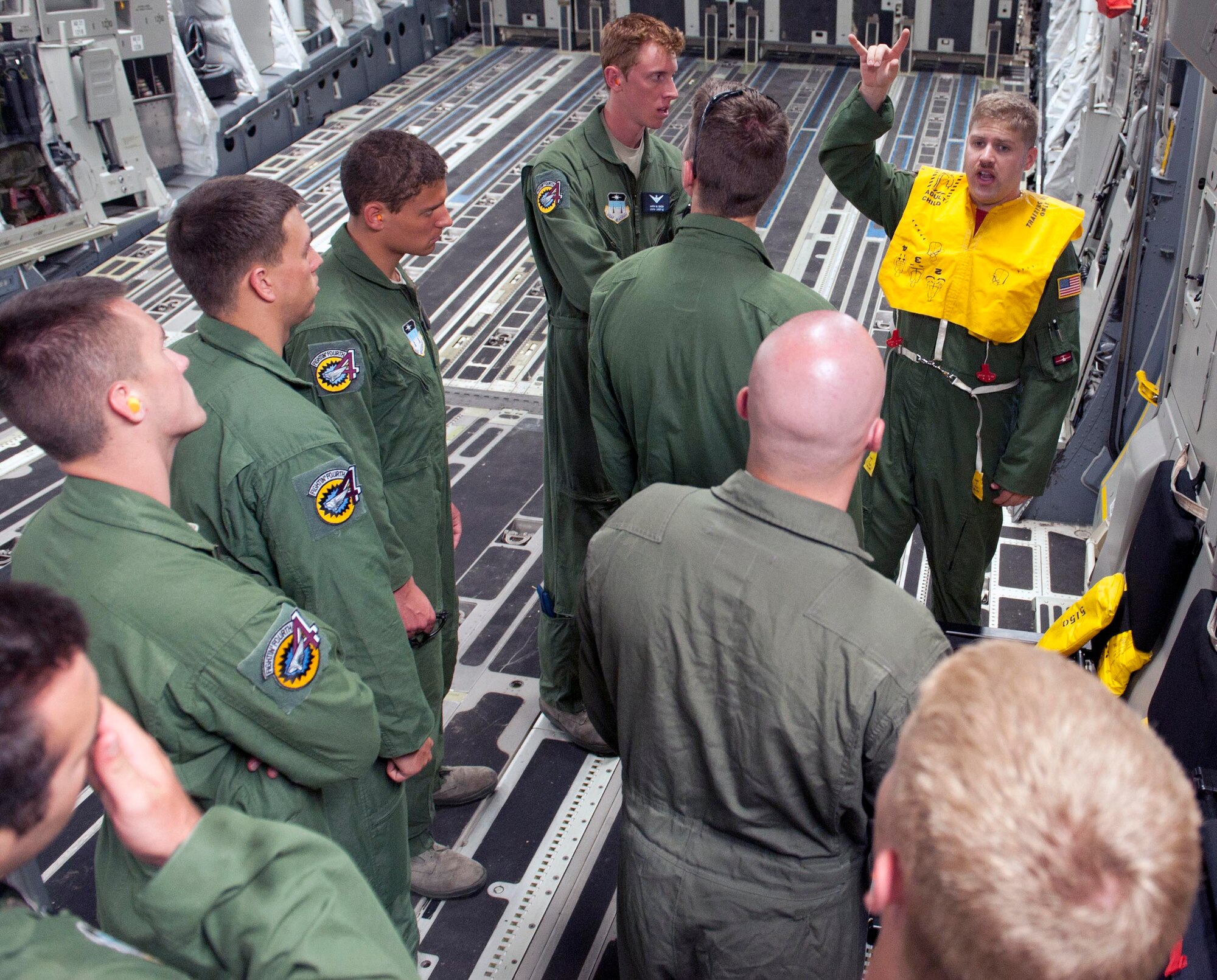 Staff Sgt. Robert Wyman, 535th Airlift Squadron loadmaster, gives a pre-flight briefing to cadets from the "Fightin' Fourth," or Fourth Cadet Squadron at the U.S. Air Force Academy in Colorado Springs, Colo. Mar. 25 at Joint Base Pearl Harbor-Hickam, Hawaii. During the 15th Wing sponsored tour, the cadets visited various agencies around base to get a glimpse of what the operational Air Force looks like. (U.S. Air Force photo by Staff Sgt. Nathan Allen)