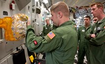 Staff Sgt. Robert Wyman, 535th Airlift Squadron loadmaster, gives a pre-flight briefing to cadets from the "Fightin' Fourth," or Fourth Cadet Squadron at the U.S. Air Force Academy in Colorado Springs, Colo. Mar. 25 at Joint Base Pearl Harbor-Hickam, Hawaii. During the 15th Wing sponsored tour, the cadets visited various agencies around base to get a glimpse of what the operational Air Force looks like. (U.S. Air Force photo by Staff Sgt. Nathan Allen)
