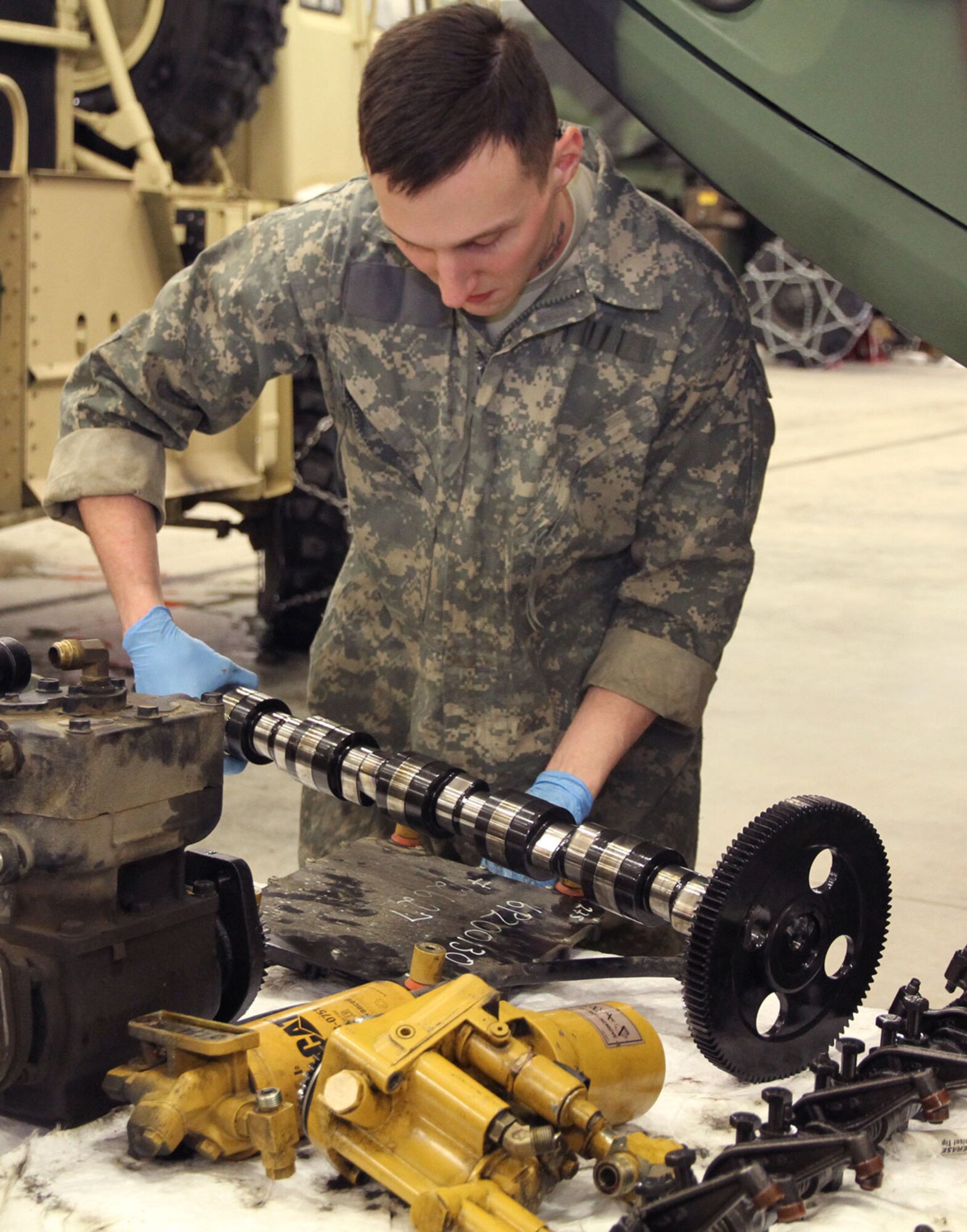 Spc. Adam Powell, Forward Support Company, 6th Engineer Battalion, inspects a crankshaft for deficiencies March 17. (U.S. Army photo/Staff Sgt. Jason Epperson)