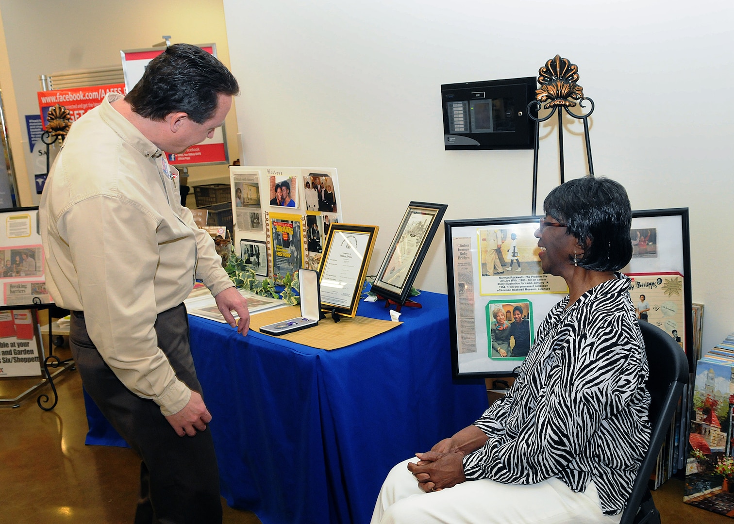 Randolph AFB, TX, 3/31/2011:  Mike Einer, manager of the Base Exchange at Randolph Air Force Base, Texas, views civil rights era documents and photographs on display by Lucille Bridges. Her daughter Ruby in 1960 was among the first African-American students to integrate New Orleans public schools. Bridges spoke to several groups at the base, and greeted people at the Base Exchange, during her visit  on March 31, 2011 as part of Women's History Month. (U.S. Air Force photo/David Terry)