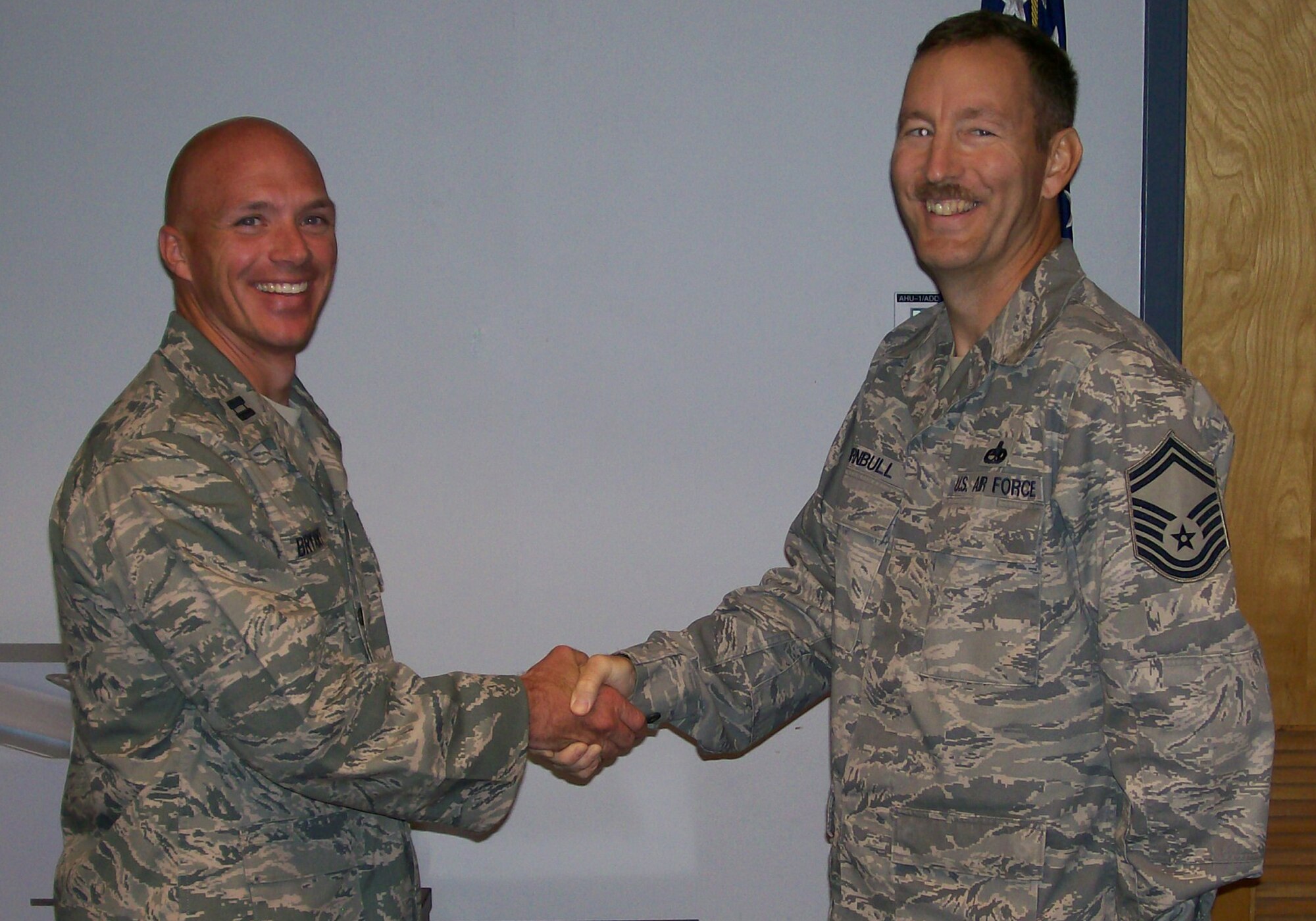 Capt. Christopher Bryant shakes hands with Senior Master Sgt. Andy Turnbull, both from the 1st Special Operations Communications Squadron Tactical Communications Flight, Hurlburt Field, Fla. The 1st SOCS initiated a base-wide bone marrow drive March 28 to help support Sergeant Turnbull who was diagnosed with acute myeloid leukemia July 19, 2010. (Courtesy Photo)