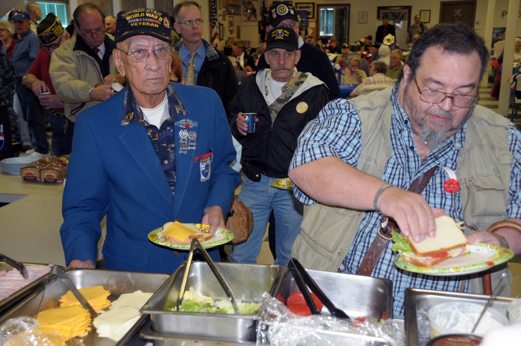 Frank Caudillo, World War II veteran and Bronze Star recipient, and Rich Calton receive a free lunch as part of Wyoming’s Veteran’s Welcome Home Day in the Veterans of Foreign Wars Post 1881 on Nation Way Avenue in Cheyenne, Wyo., March 30. (U.S. Air Force photo by Blaze Lipowski)