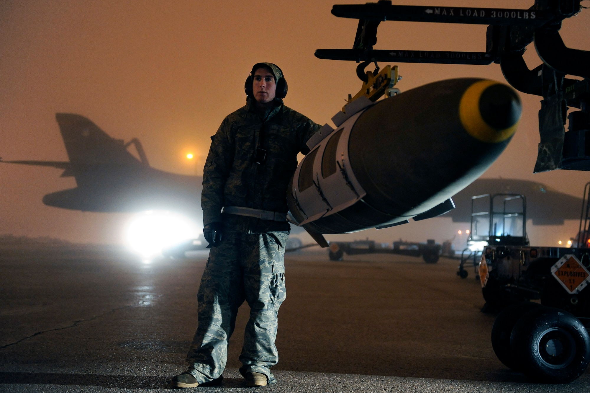 Airman Michael Doto, 28th Aircraft Maintenance Squadron weapon systems technician, steadies a GBU-31 joint direct attack munition while preparing to load it on a B-1B Lancer on Ellsworth Air Force Base, S.D., March 27, 2011.  B-1B Lancers from the 28th Bomb Wing launched early Sunday, March 27 to strike targets in Libya from their home station of Ellsworth Air Force Base in support of Operation Odyssey Dawn. (U.S. Air Force photo/Staff Sgt. Marc I. Lane)  