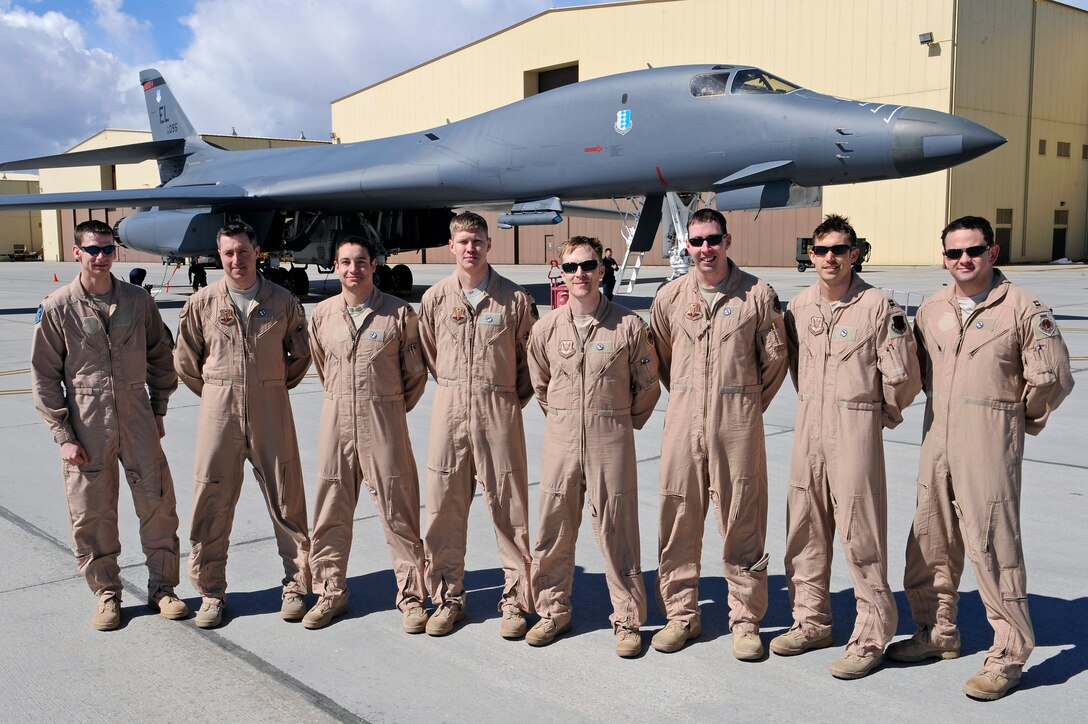The two aircrews from the 34th Bomb Squadron and 28th Operations Support Squadron stand in front of a B-1B at Ellsworth Air Force Base, S.D., March 30, 2011.  Two B-1B Lancers from the 28th Bomb Wing launched early Sunday, March 27 from Ellsworth Air Force Base to strike targets in Libya in support of Operation Odyssey Dawn. (U.S. Air Force photo/Staff Sgt. Marc I. Lane)