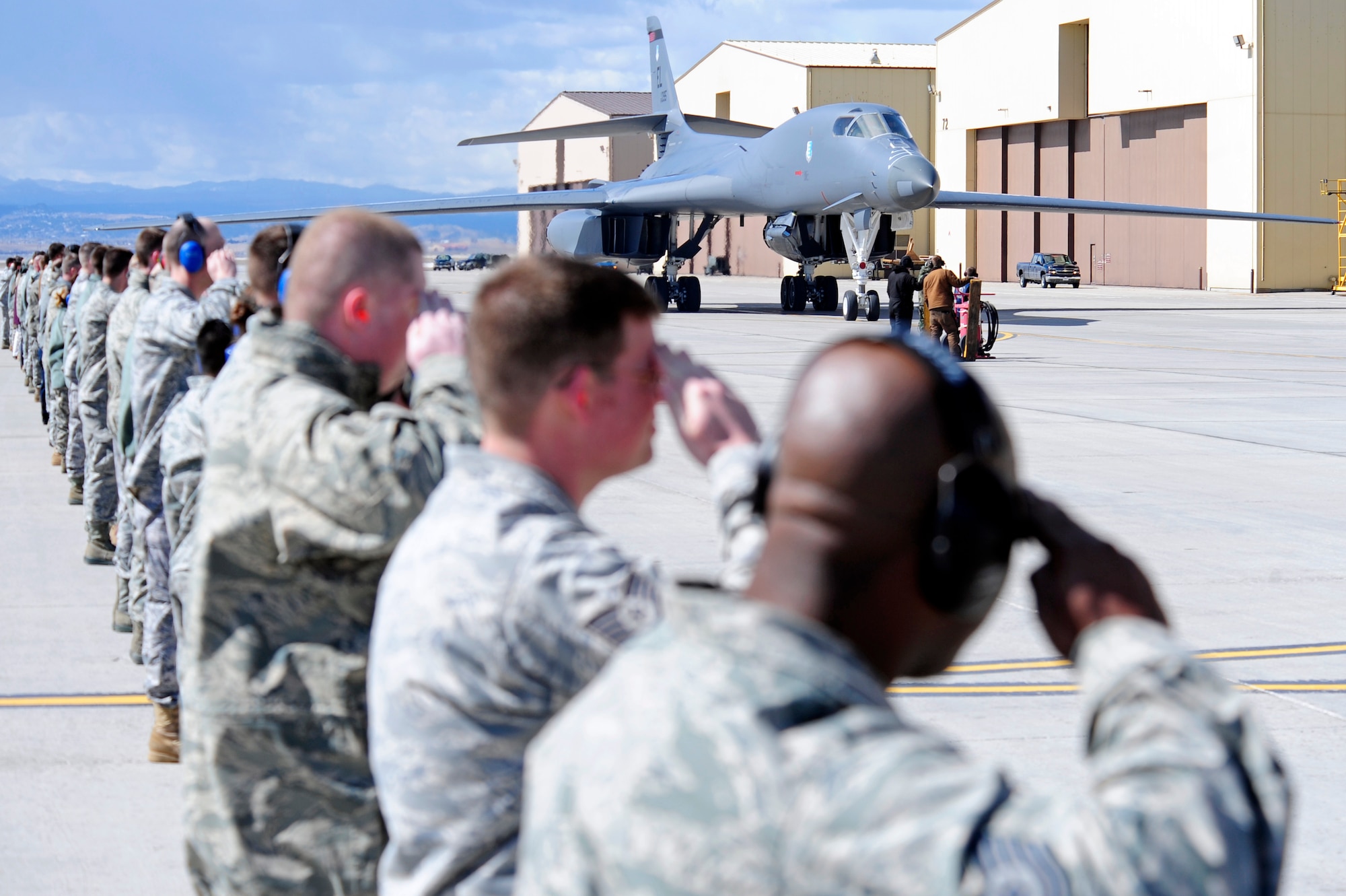 Airmen from the 28th Bomb Wing salute two returning B-1B Lancers as they taxi to their parking area on Ellsworth Air Force Base, S.D., March 30, 2011.  The B-1s struck targets in Libya in support of Operation Odyssey Dawn. (U.S. Air Force photo/Staff Sgt. Marc I. Lane)