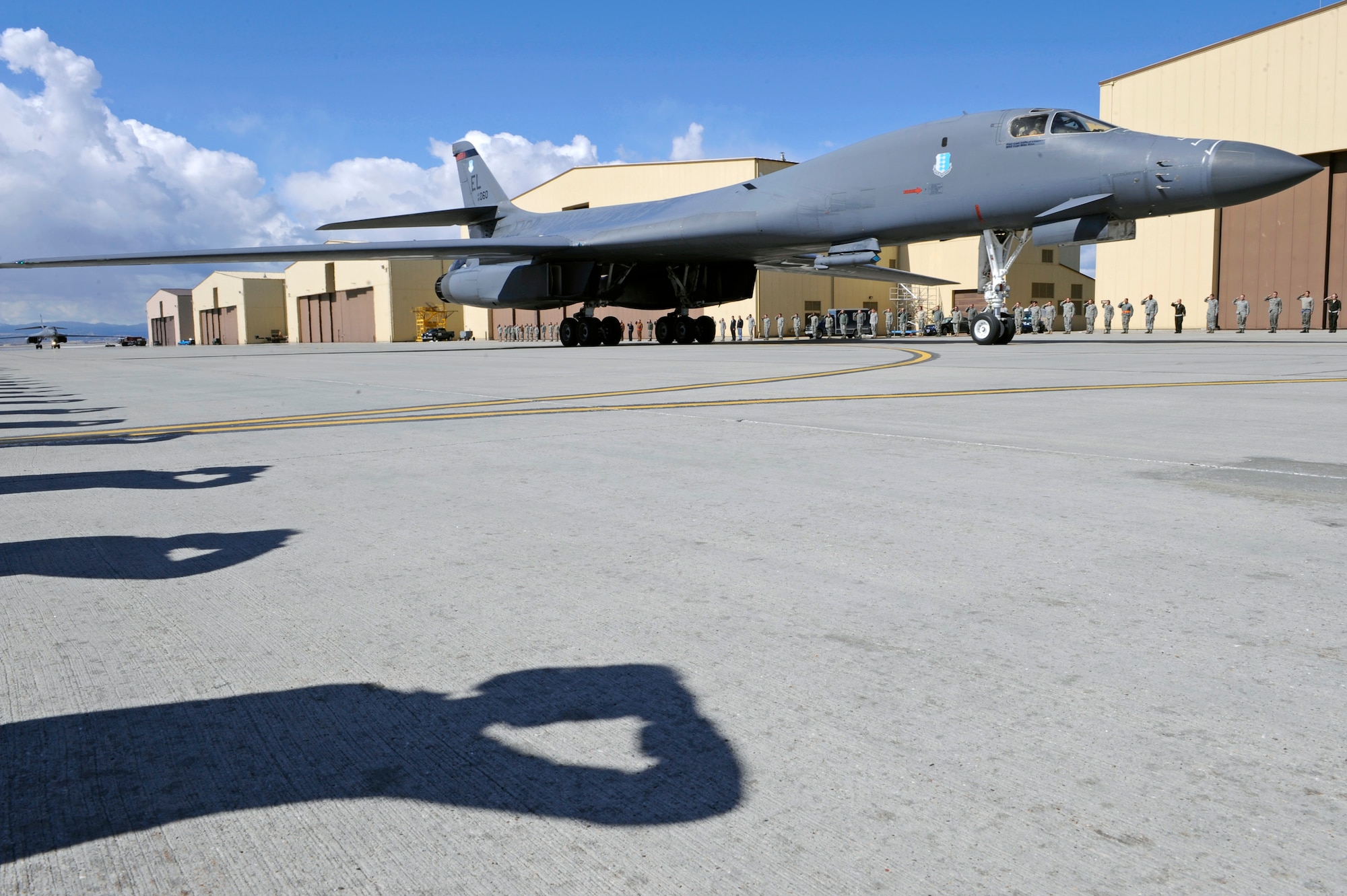 Airmen from the 28th Bomb Wing salute two B-1B Lancers as they taxis to their parking area on Ellsworth Air Force Base, S.D., March 30, 2011.  The returning B-1s struck targets in Libya in support of Operation Odyssey Dawn. (U.S. Air Force photo/Staff Sgt. Marc I. Lane)