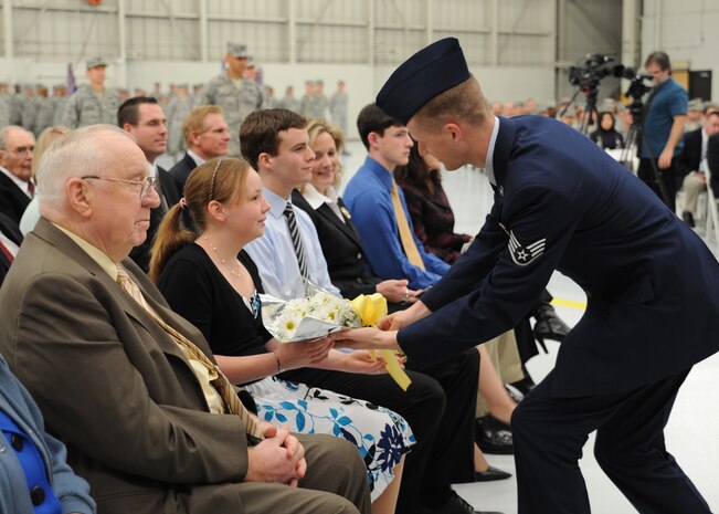 Miss Elizabeth Hansen receives a bouquet of flowers welcoming her to Charleston during the 437th Airlift Wing change of command ceremony March 29, on Joint Base Charleston, S.C. Miss Hansen is the daughter of Col. Rik Hansen, the 437th Airlift Wing commander. (U.S. Air Force photo/Staff Sgt. Katie Gieratz)