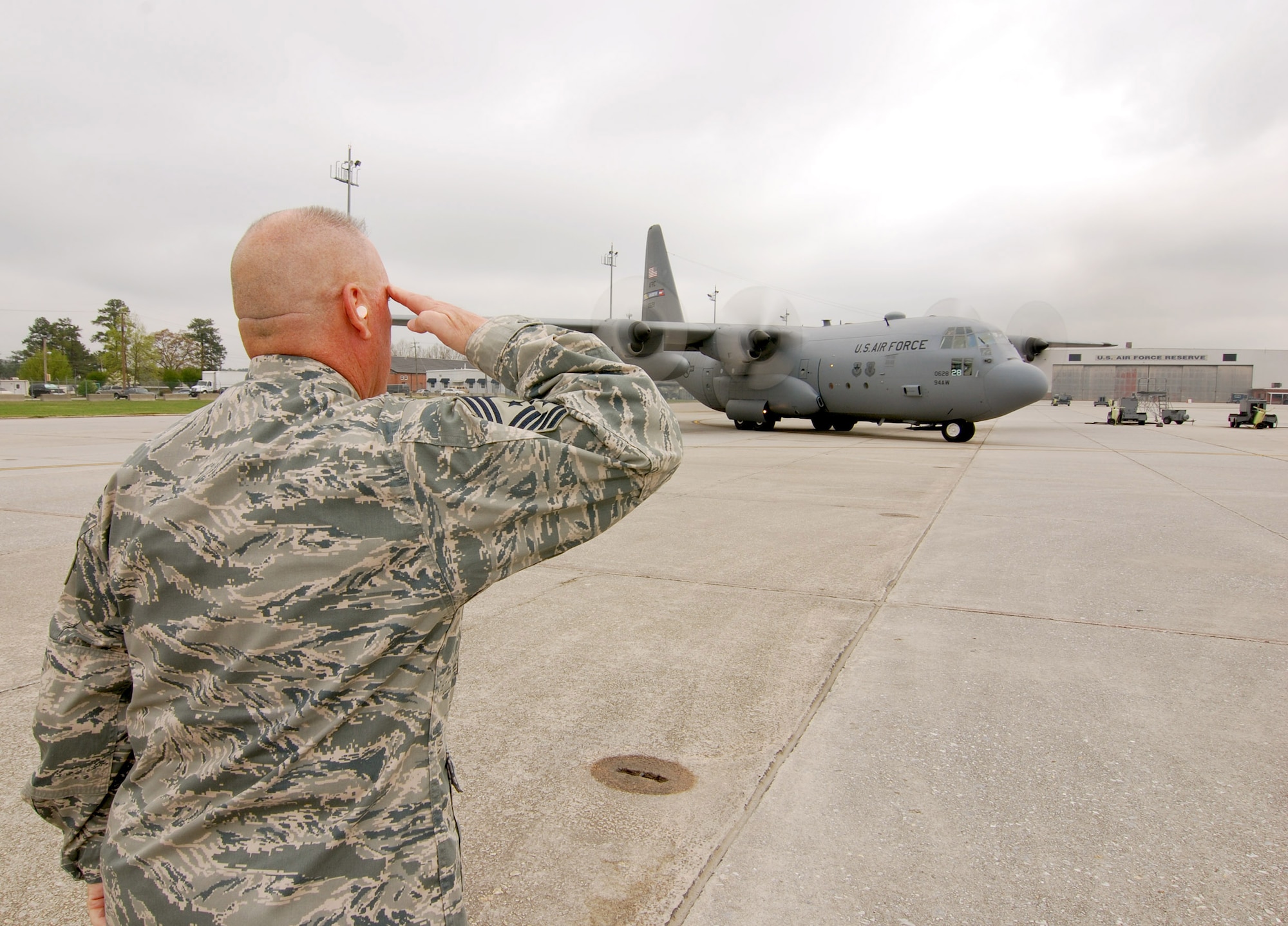 94th Airlift Wing Command Chief, Chief Master Sgt. John Anderson, salutes a C-130H2 Air Force Reserve aircraft departing Dobbins Air Reserve Base, Mar 31.  Chief Anderson was on the Dobbins ARB flight line to help launch one of the Wing's aircraft prior to the Chief's retirement this weekend, after 33 years of active and reserve Air Force duty.   (U.S. Air Force photo/ Brad Fallin)