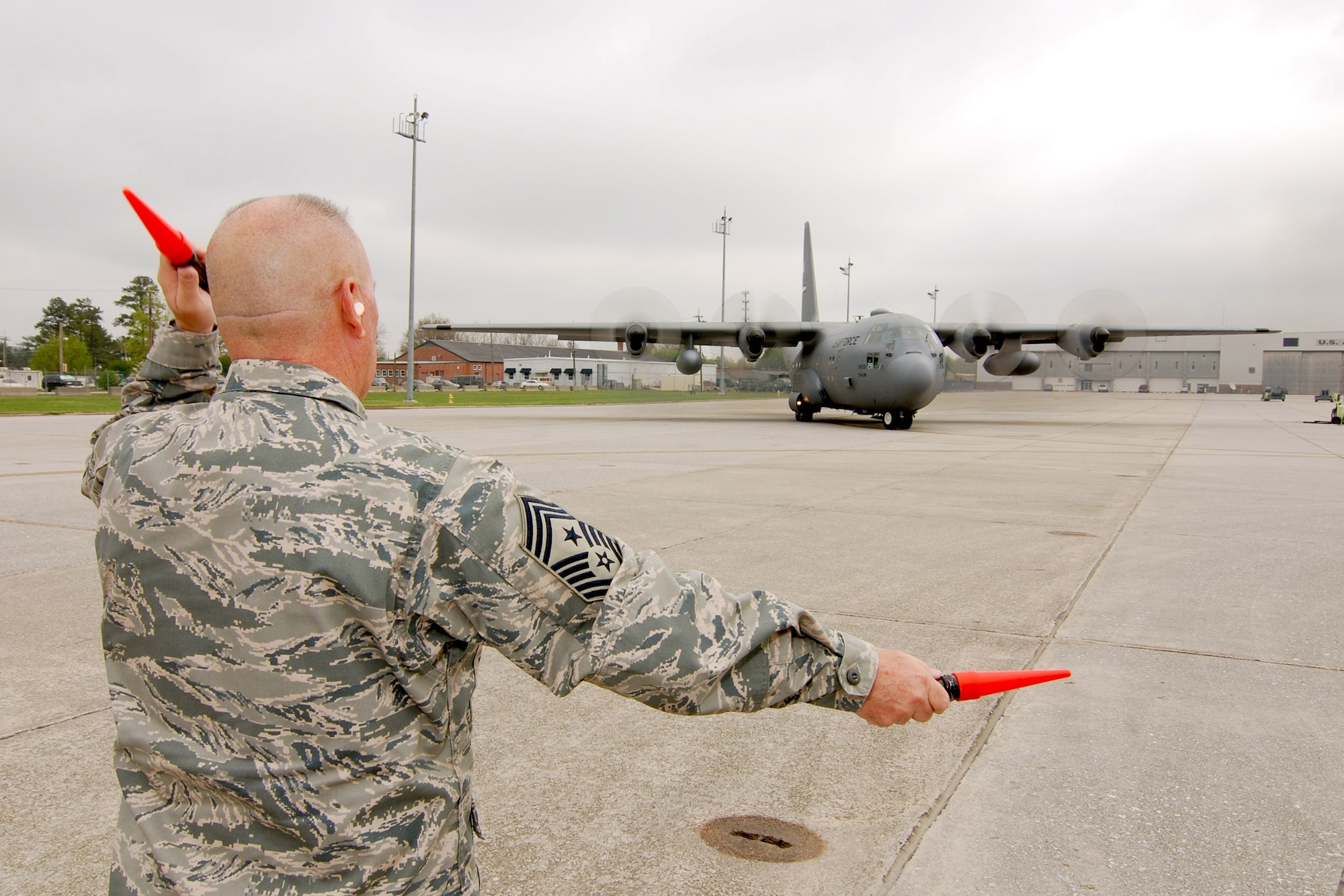 94th Airlift Wing Command Chief, Chief Master Sgt. John Anderson, marshals a C-130H2 Air Force Reserve aircraft departing Dobbins Air Reserve Base, Mar 31.  Chief Anderson was on the Dobbins ARB flight line to help launch one of the Wing's aircraft prior to the Chief's retirement this weekend, after 33 years of active and reserve Air Force duty.   (U.S. Air Force photo/ Brad Fallin)