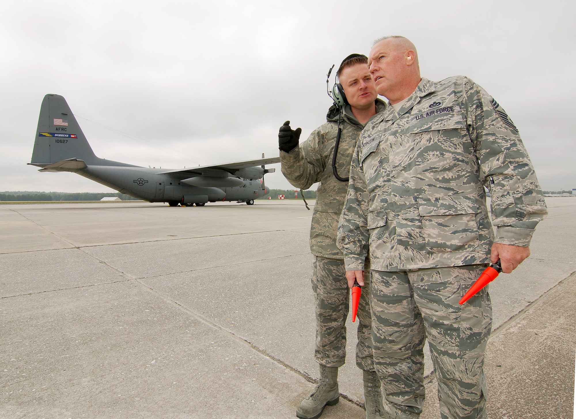 Staff Sgt. Bradley Harrell, 94th Aircraft Maintenance Flight, provides some last minute on the job training for 94th Airlift Wing Command Chief, Chief Master Sgt. John Anderson, Mar 31.  Chief Anderson was on the Dobbins ARB flight line to help launch one of the Wing's aircraft prior to the Chief's retirement this weekend, after 33 years of active and reserve Air Force duty.   (U.S. Air Force photo/ Brad Fallin)
