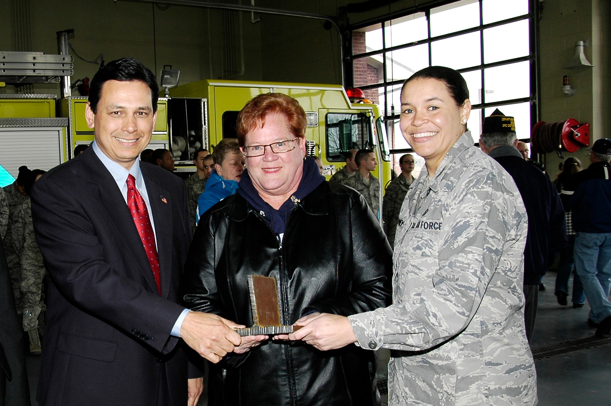 U.S. Representative Steve Austria, Mayor Joan Dautel, and Col. Amanda Gladney hold a small piece of steel girder from New York's World Trade Center during a cermony March 25, 2011 in Fairborn, Ohio.  This piece will be taken to local schools to teach about the events that occurred on 9/11. A larger beam from Ground Zero will become part of a memorial at the Wright State University National Center for Medical Readiness, which trains first responders.  Congressman Austria represents Ohio's 7th District, Ms. Dautel is Mayor of Fairborn and Col. Gladney is commander of the 88th Air Base Wing at Wright-Patterson Air Force Base, Ohio. (Skywrighter photo/Niki Jahns)