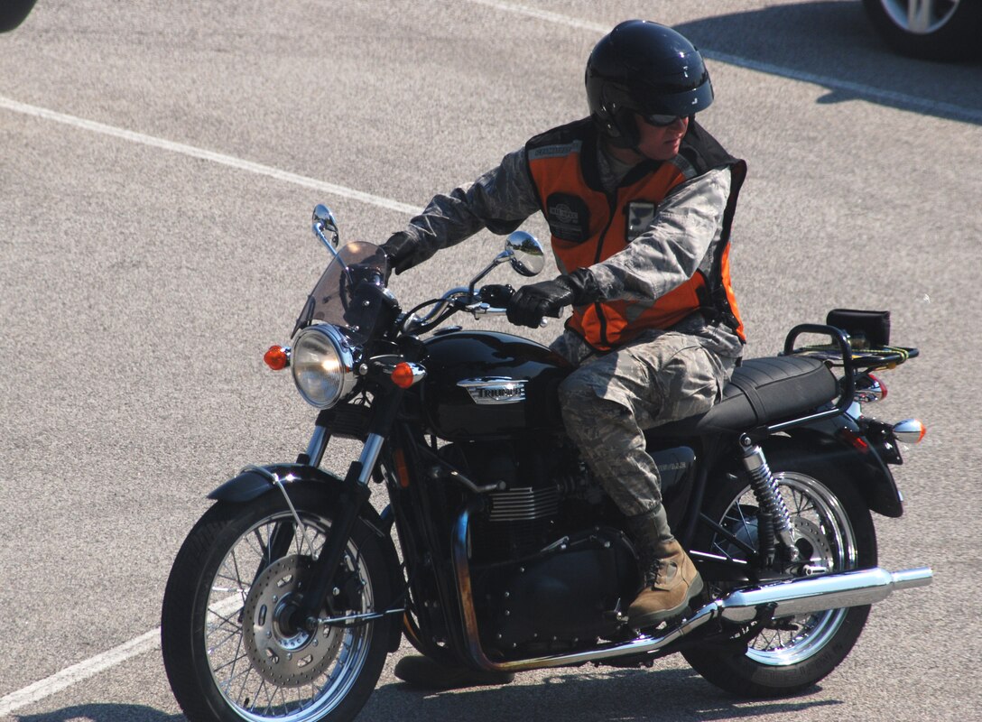 932nd Maintenance Group commander, Col. James McDonnell, looks for oncoming traffice before engaging first gear.  He reminds bikers and motorists alike to pay attention to their surroundings.  "For the riders, give your bike a thorough inspection before firing up that engine for the first time in months. Inspect your personal protection equipment, too; maybe it is time to get new goggles and gloves. And please take it easy on those first few rides, while you get re-accustomed to your bike and knock the rust and cobwebs off your riding skills," he said.  A base-wide Motorcycle Safety Day is April 14, and begins at 0900 with a Scott AFB Motorcycle Safety "All Call" for those who ride motorcycles in the Base Theater. After the All Call, the Motorcycle Safety Day afternoon events will continue at the pavilions next to ALS starting at 11 a.m. until 3 p.m. The focus of the event is to promote motorcycle safety and rider awareness throughout Team Scott. All military, DOD civilian, contractor riders and anyone who is considering operating or purchasing a motorcycle are invited to participate. (U.S. Air Force photo/Maj. Stan Paregien)